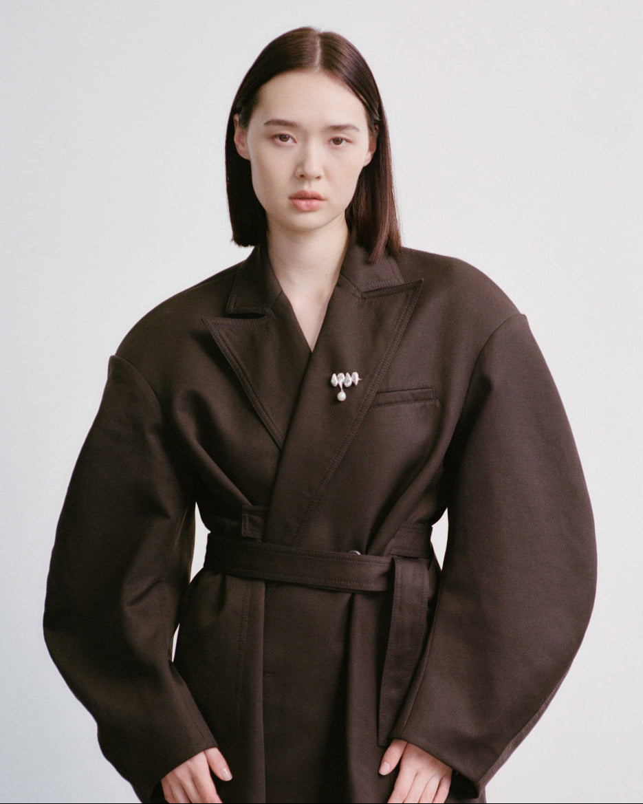 Person wearing AGMES .925 Sterling Silver Joy Brooch with Baroque Pearl Drop on black blazer. 