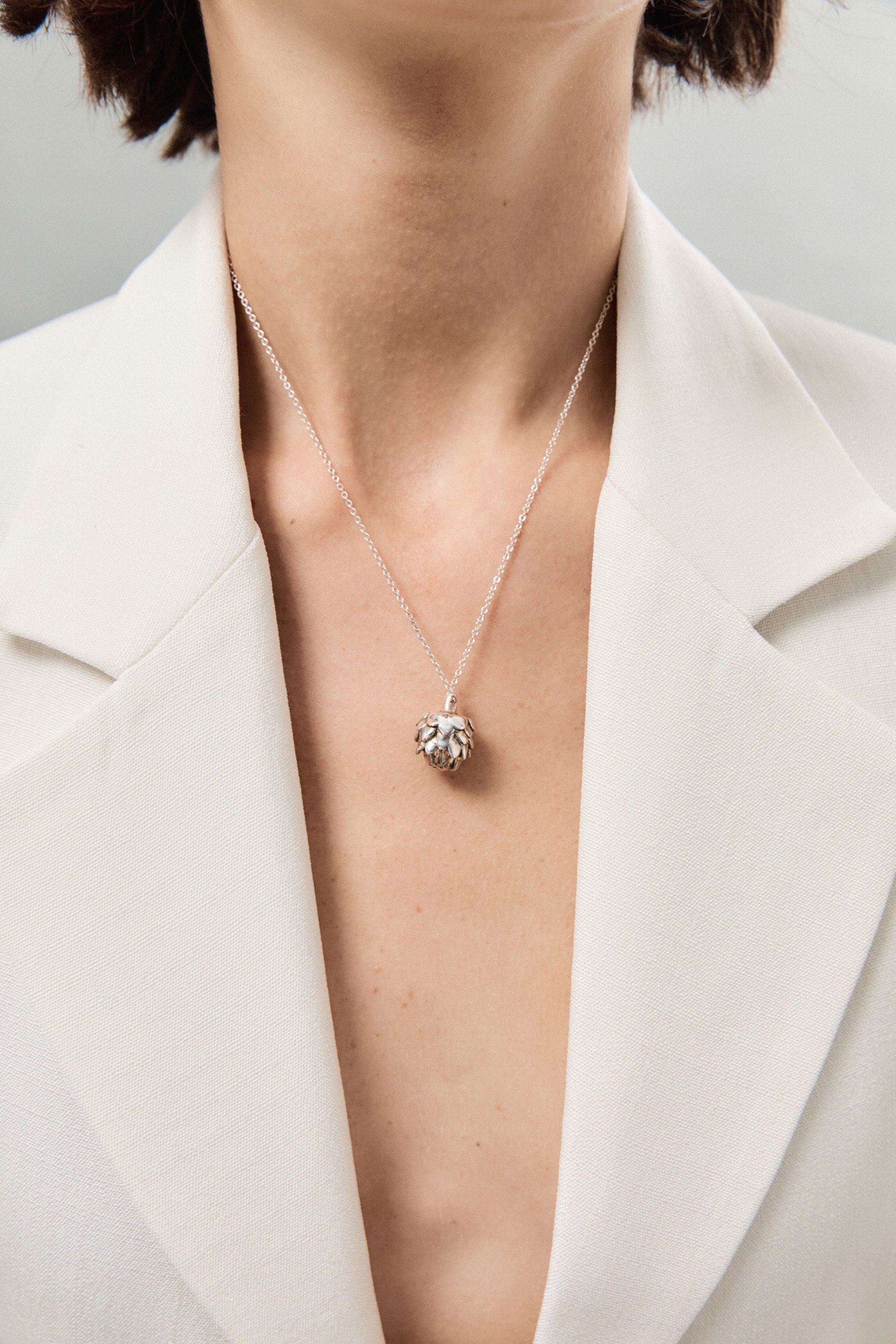 Person wearing AGMES 0.925 Sterling Silver Mini Artichoke Pendant Necklace 