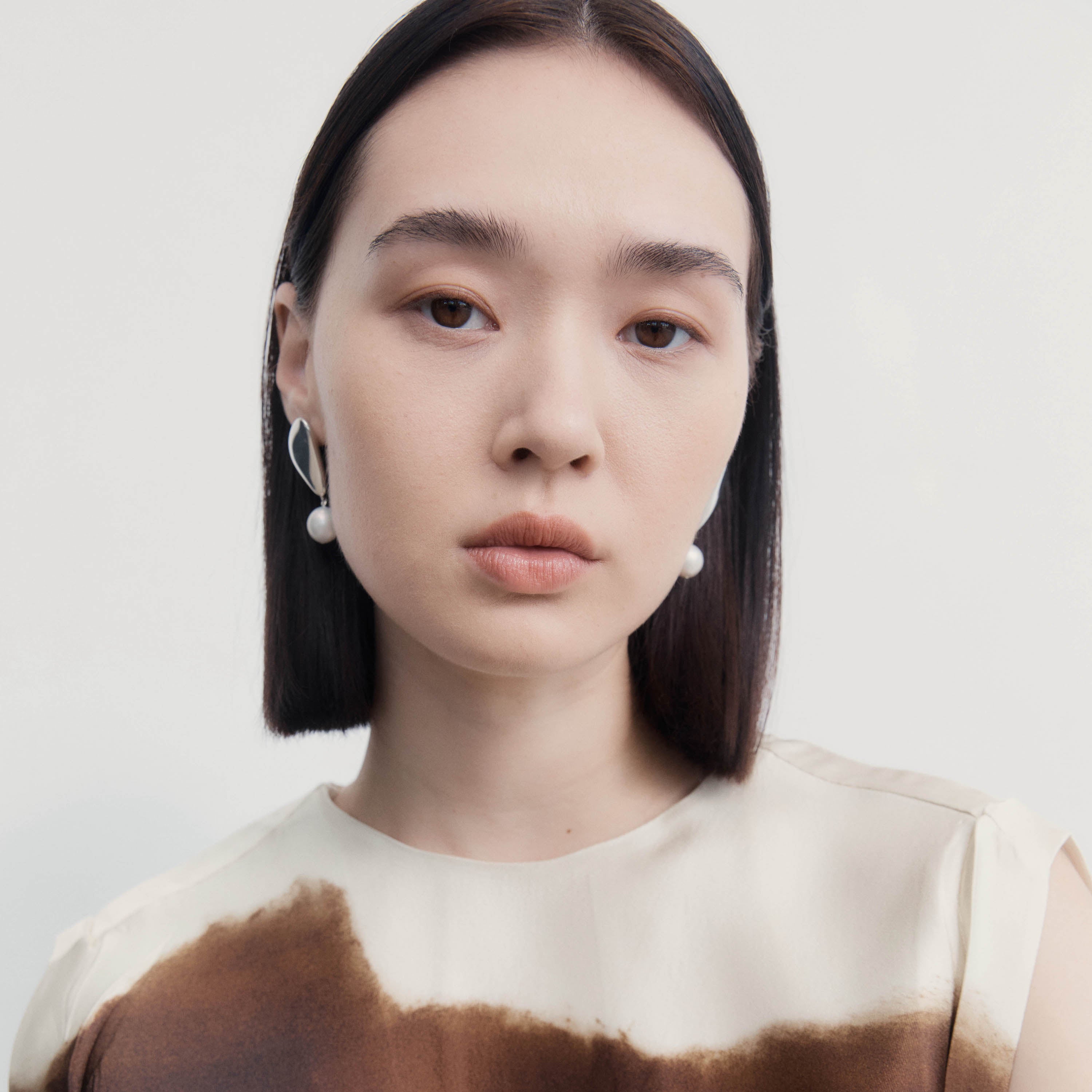 Woman wearing the AGMES .925 Sterling Silver Sherri Earrings with freshwater baroque pearl drop. 