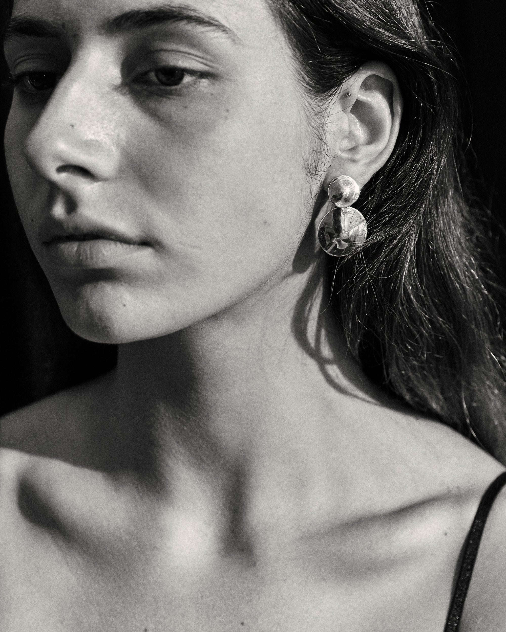 Women wearing AGMES 0.925 sterling silver short circular round drop earrings.