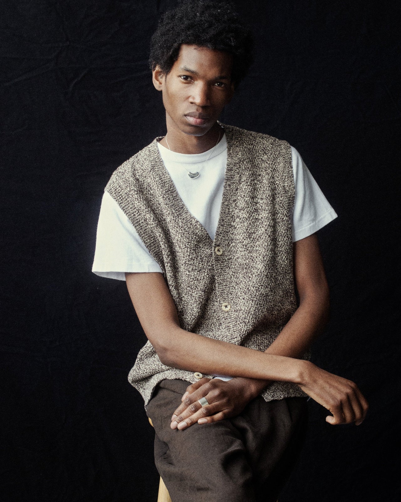 Man wearing AGMES .925 Sterling Silver Small Sculpted Heart Pendant.