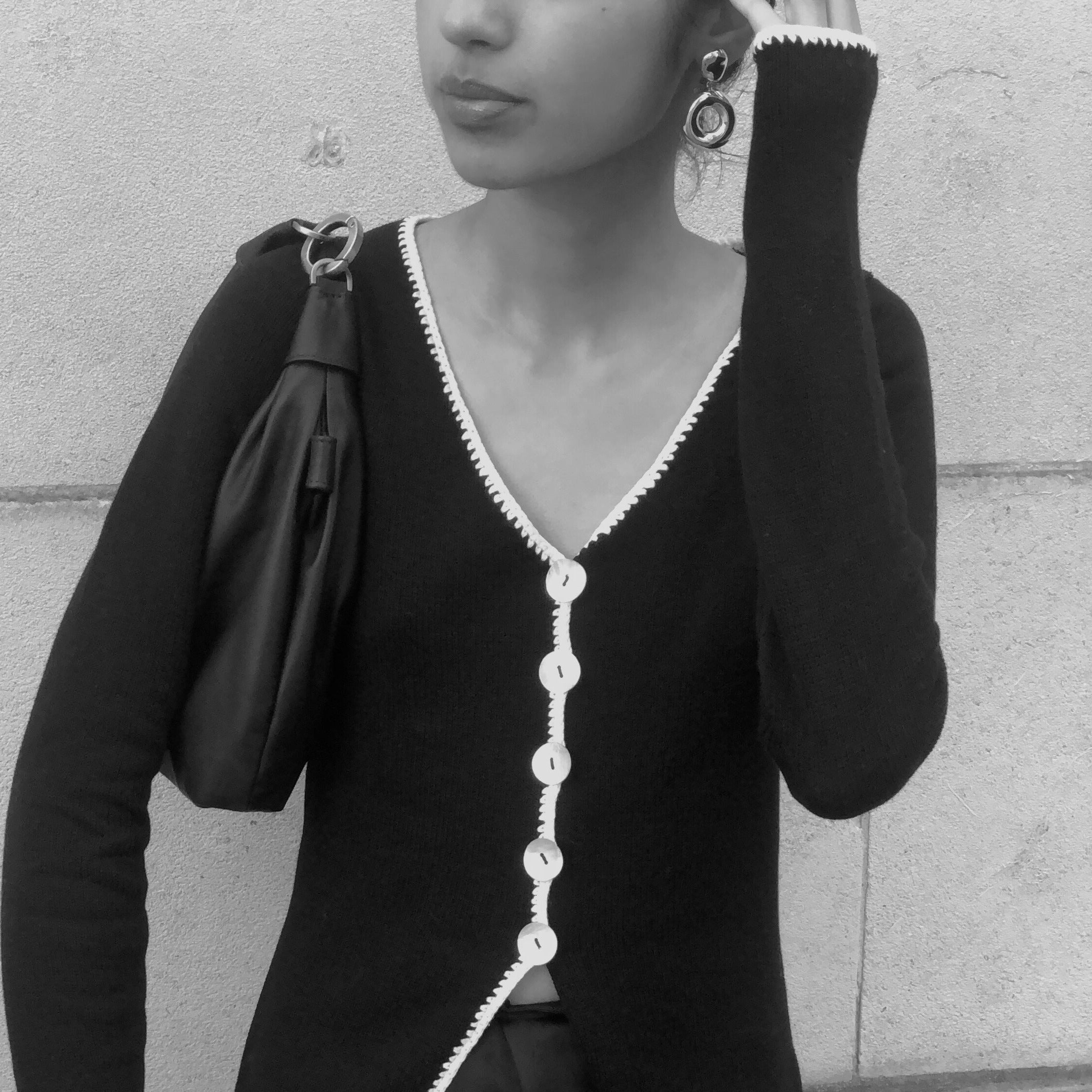 Woman wearing AGMES 0.925 sterling silver earrings with silver drop donut ring.