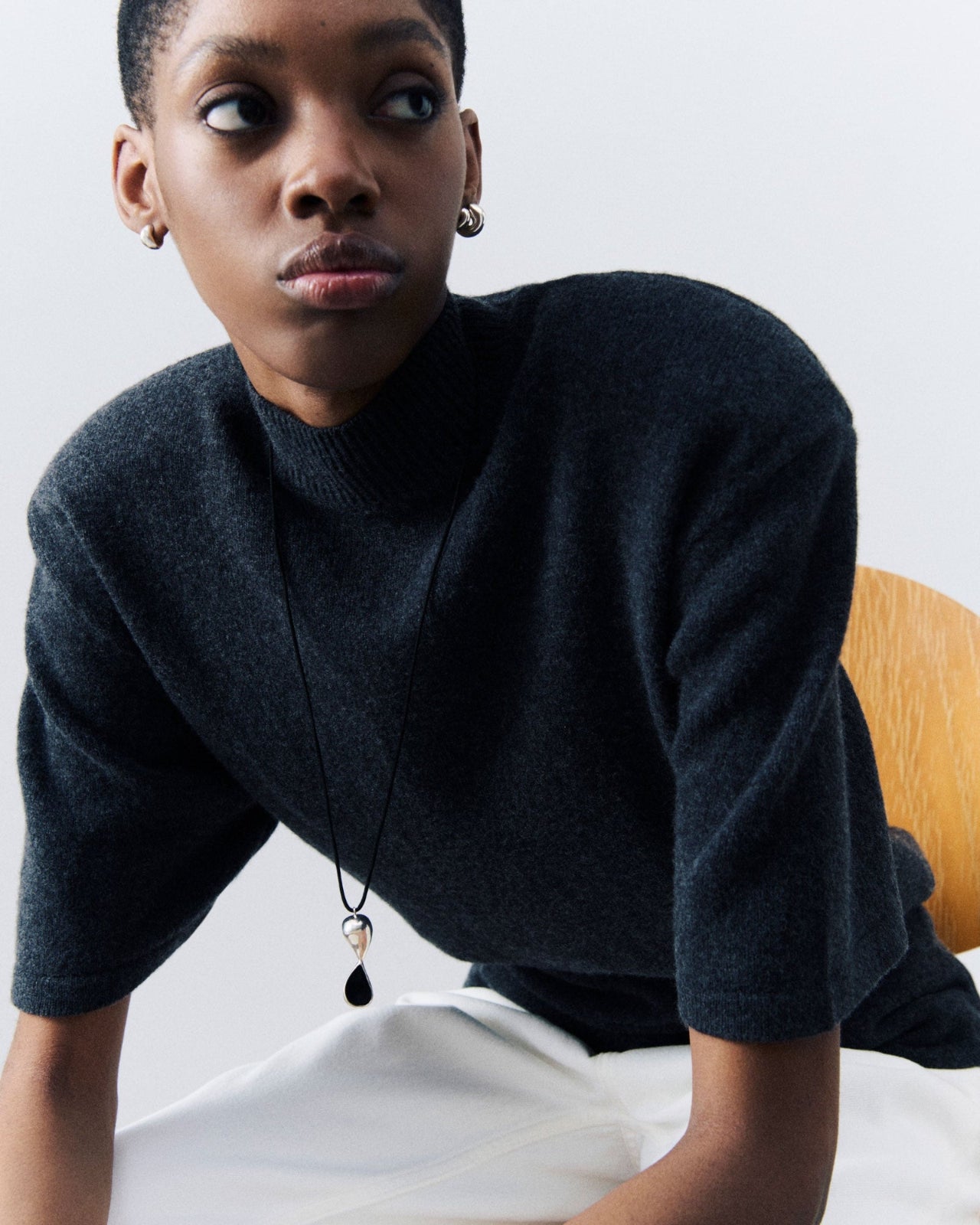 Model wearing AGMES .925 Sterling Silver Inti Pendant on Black Suede cord with Small Dahlia Hoop Earrings