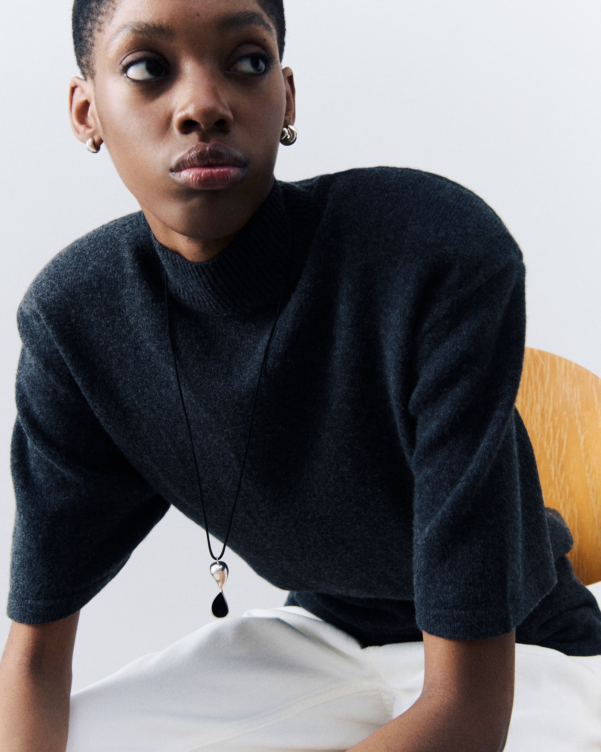 Model wearing AGMES .925 Sterling Silver Inti Pendant on Black Suede cord with Small Dahlia Hoop Earrings