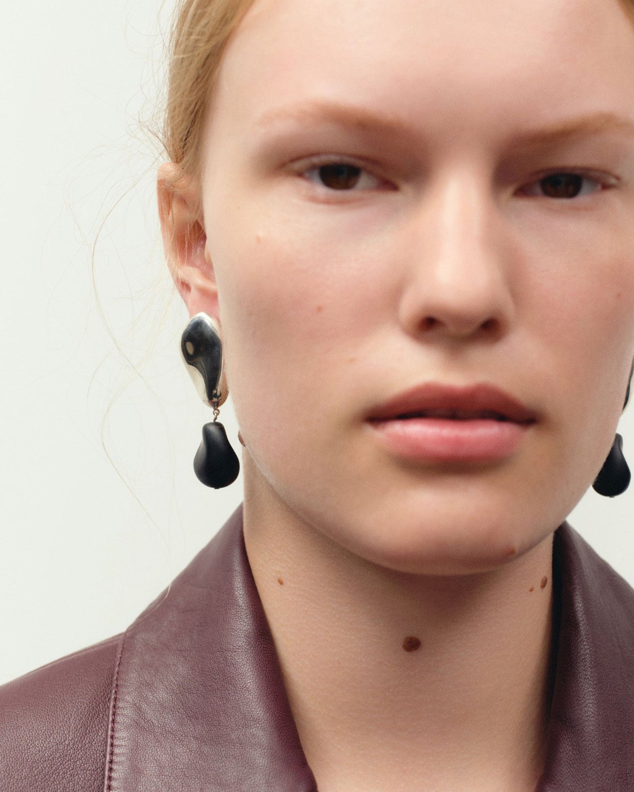 AGMES .925 sterling silver oval shaped earrings with black onyx bead drop on model