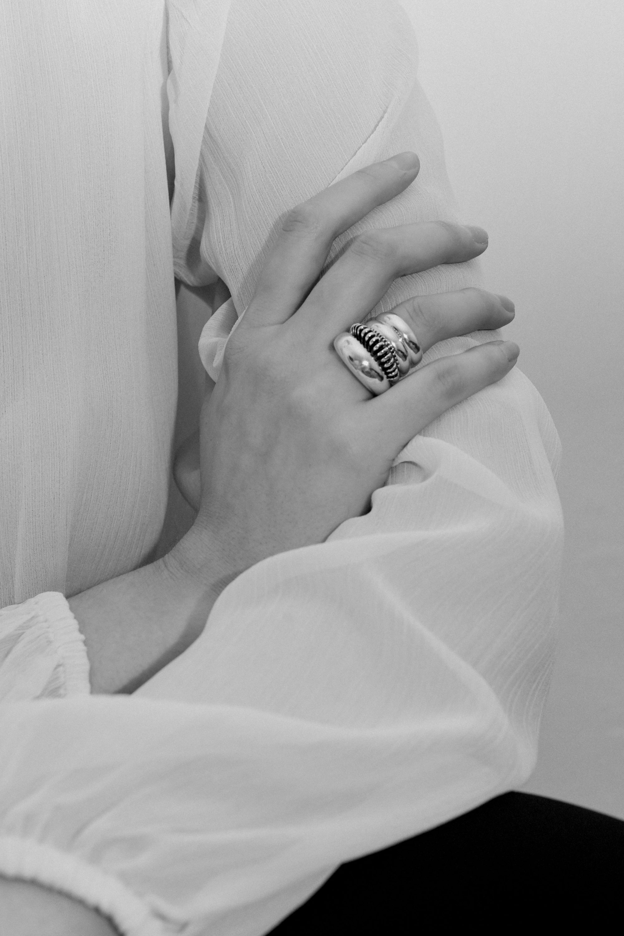 Person wearing AGMES 0.925 sterling silver Bertrand Ring, Domed Ring, and Ridge Ring Set.
