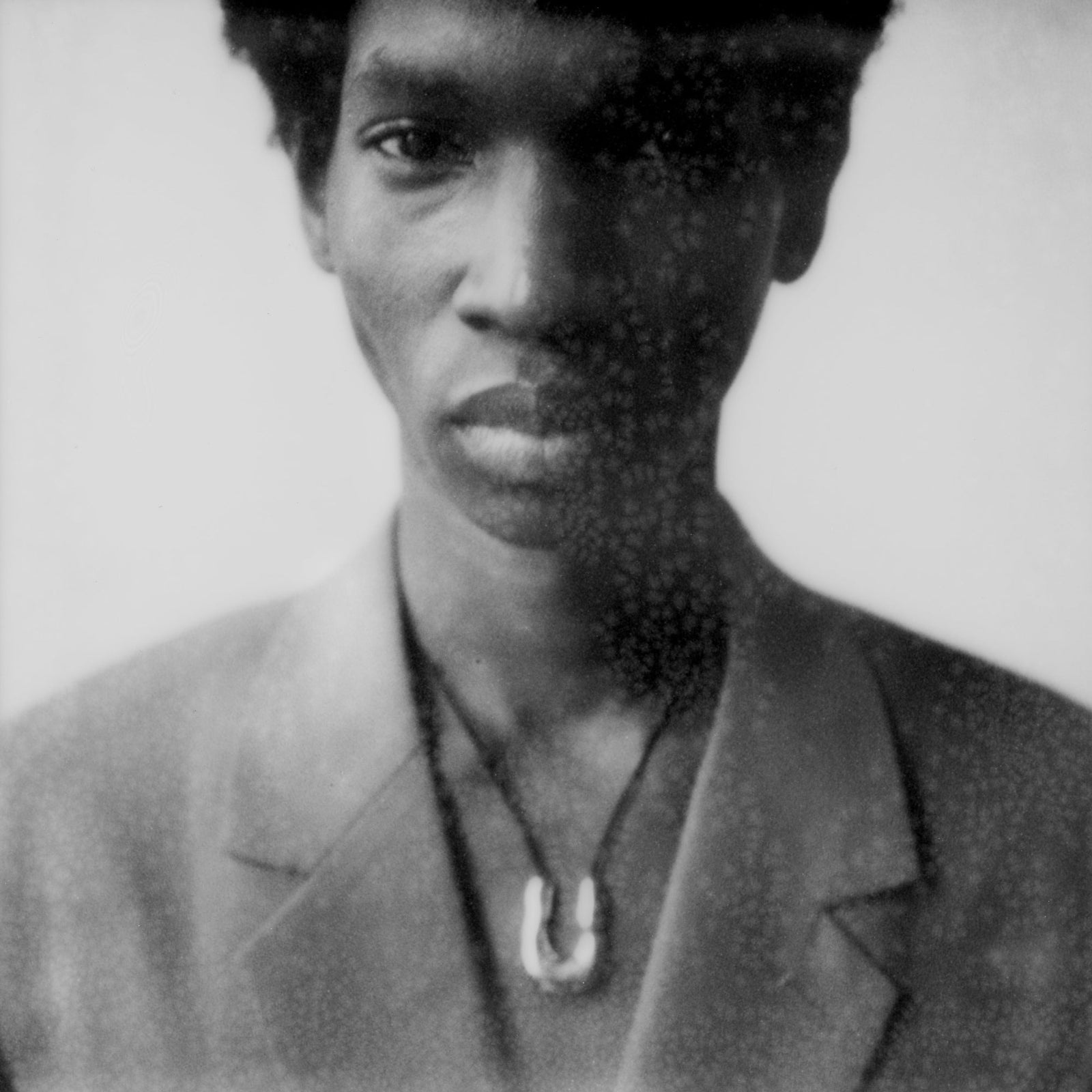 Person wearing AGMES 925 sterling silver wishbone pendant on Black Suede cord.