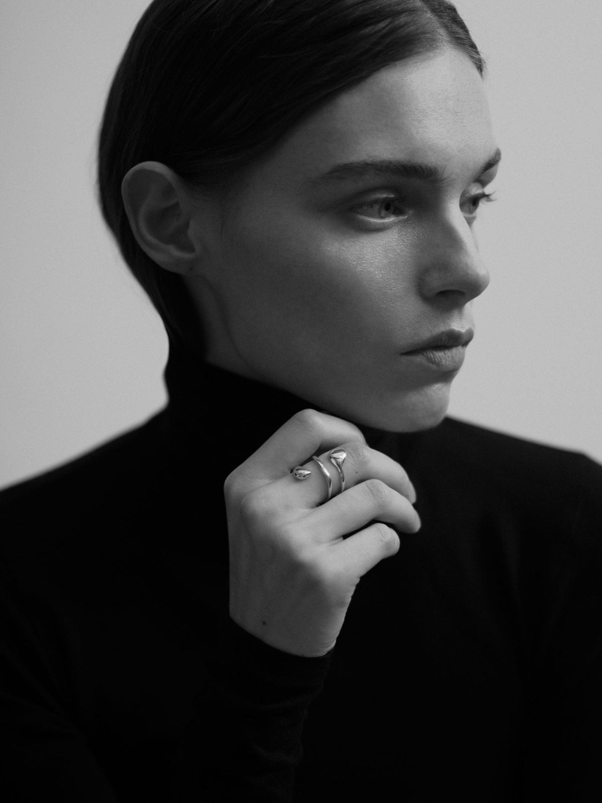 Model wearing AGMES .925 sterling silver dual flora ring. Double wrap ring. Image in black and white.