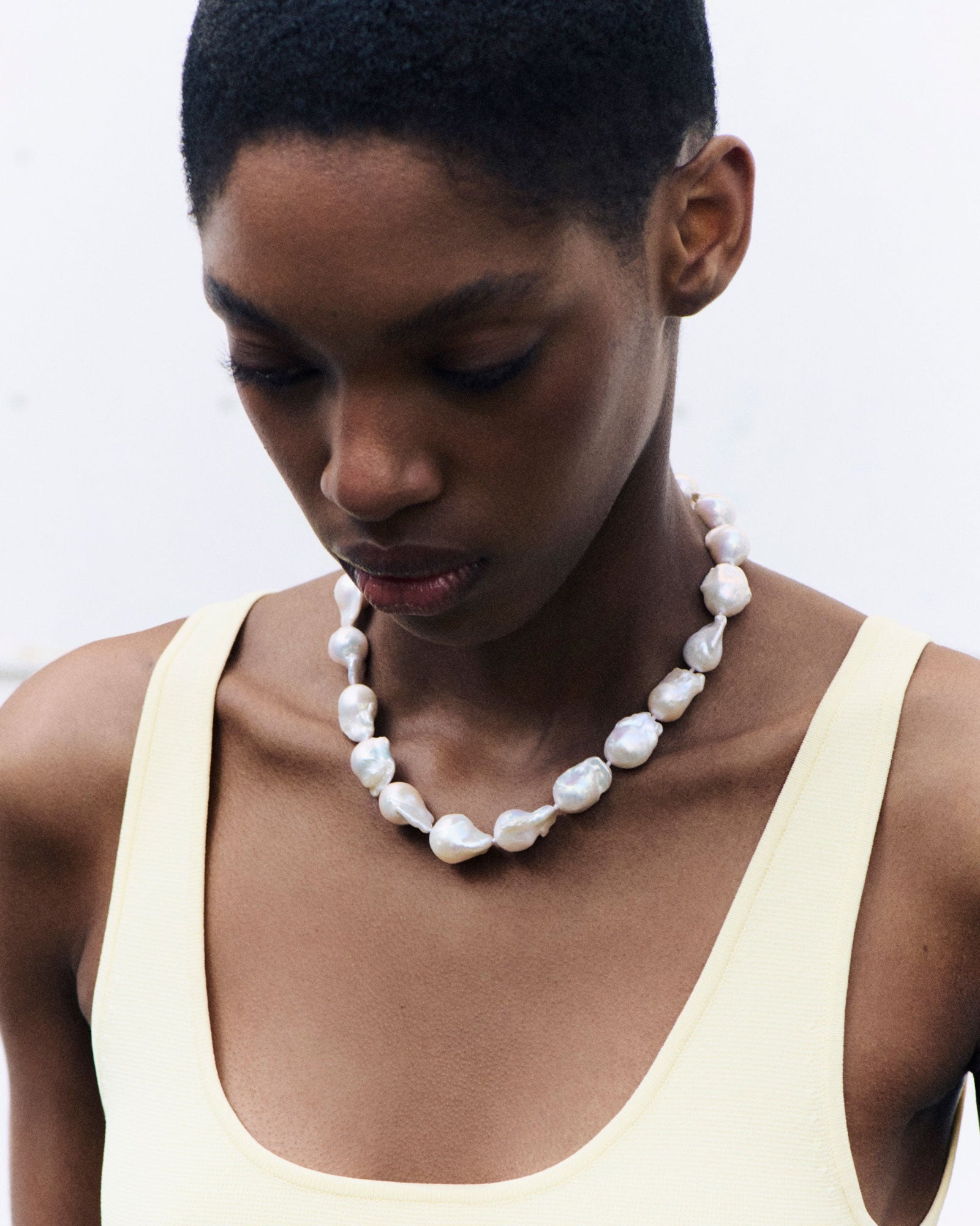 Model wearing AGMES Baroque Pearl collar Necklace with yellow dress