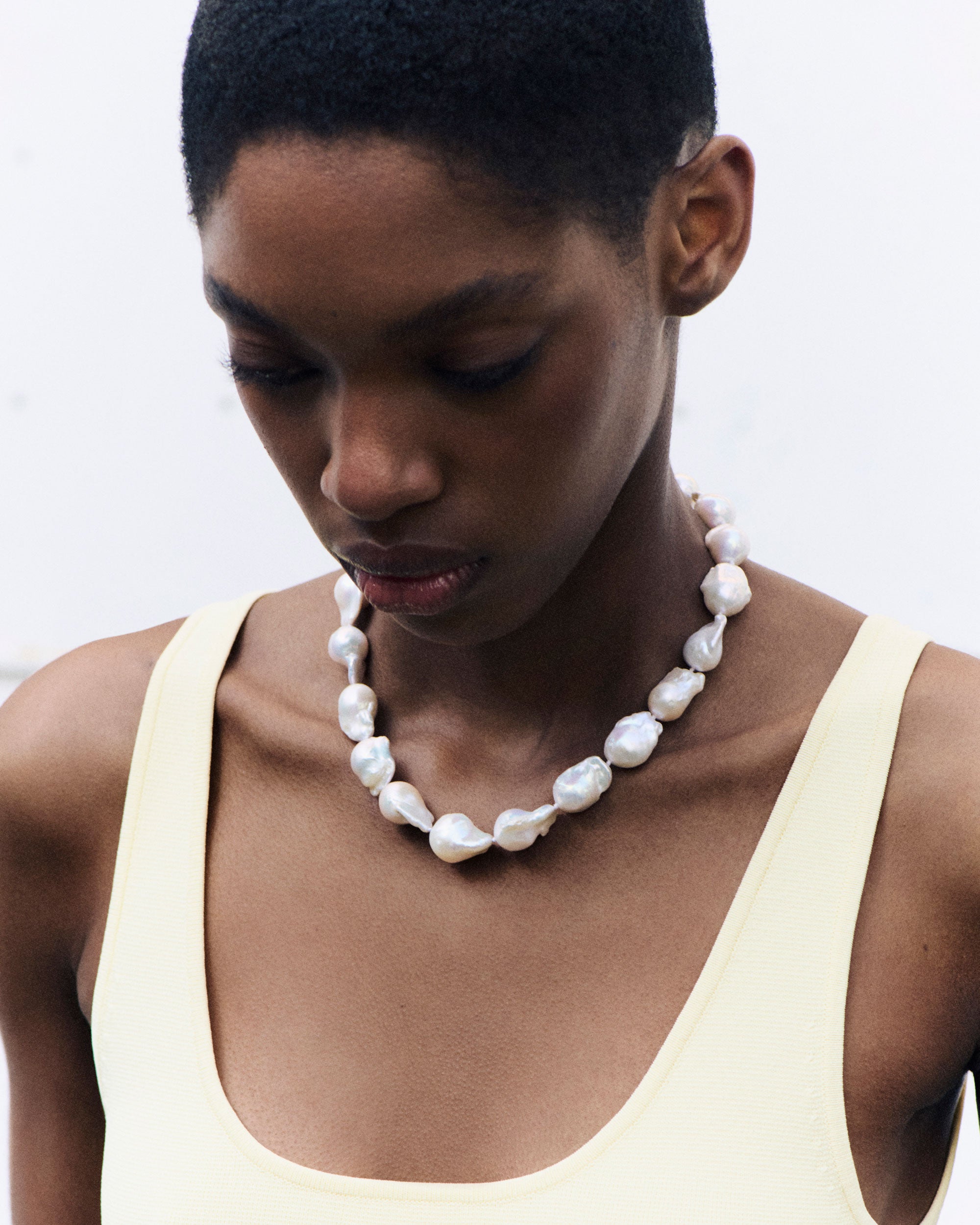 Model wearing AGMES Baroque Pearl collar Necklace with yellow dress