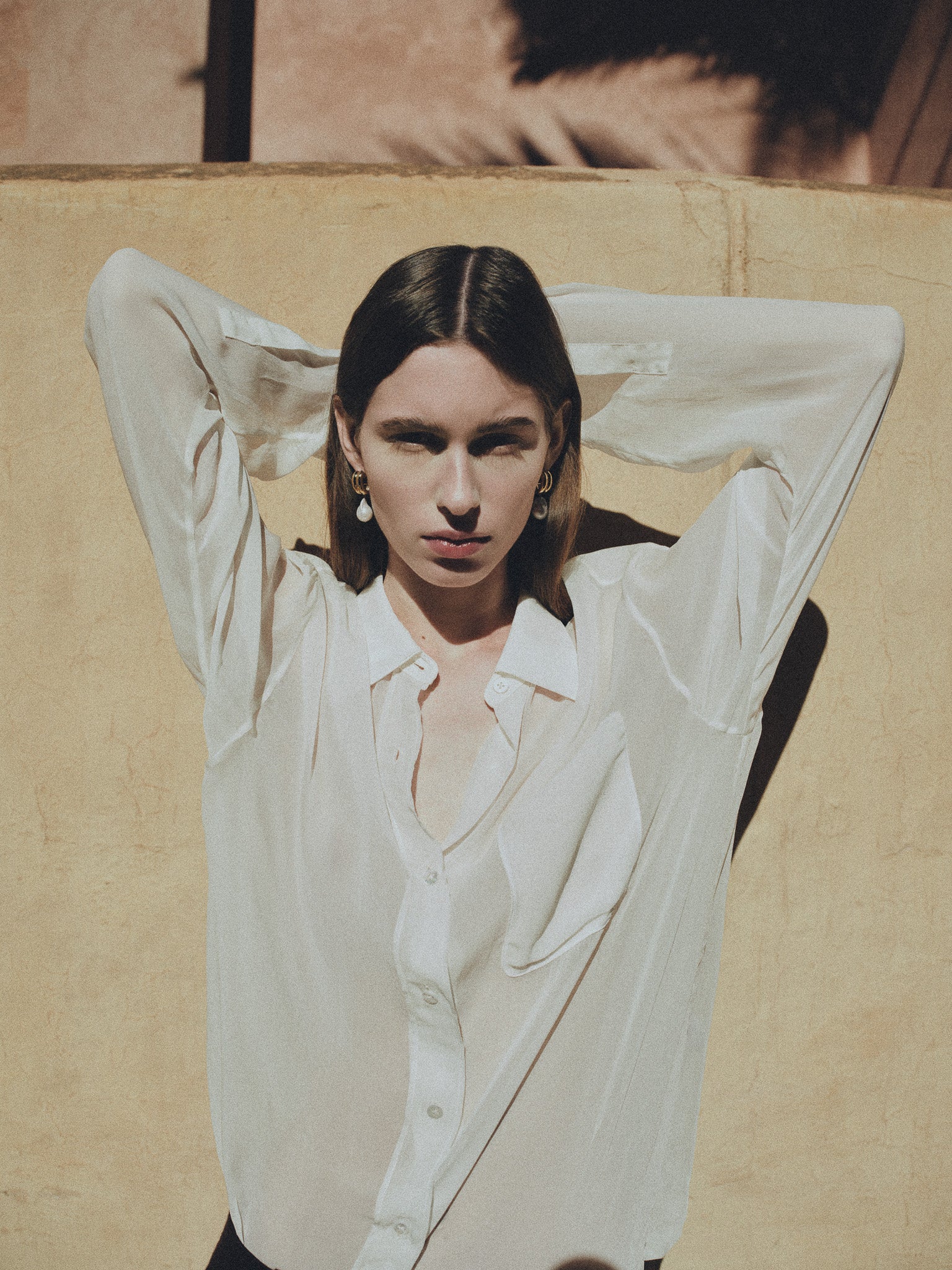 Woman wearing AGMES yellow gold vermeil baroque Juliette earrings with freshwater pearl drop.