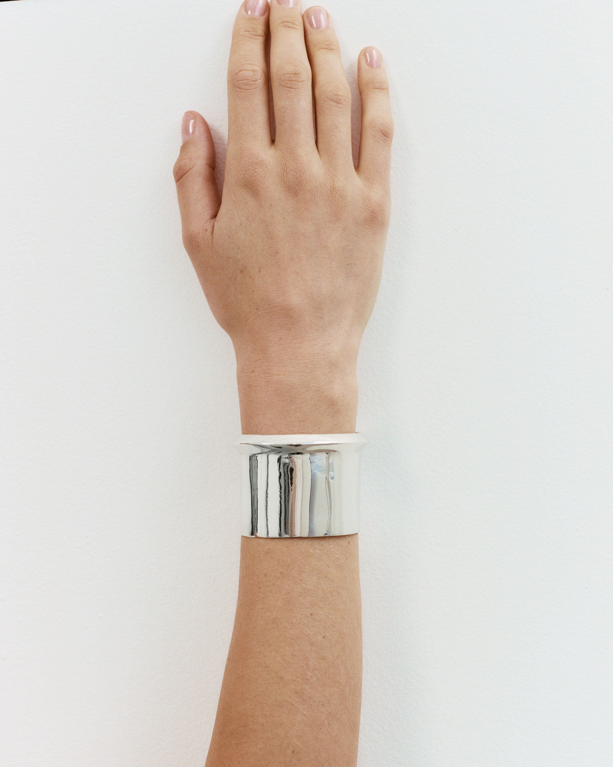 AGMES Cliff_Cuff Simple and modern cuff with a geometric scallop detail on one edge. Measures 1-7/8" wide, sterling silver.