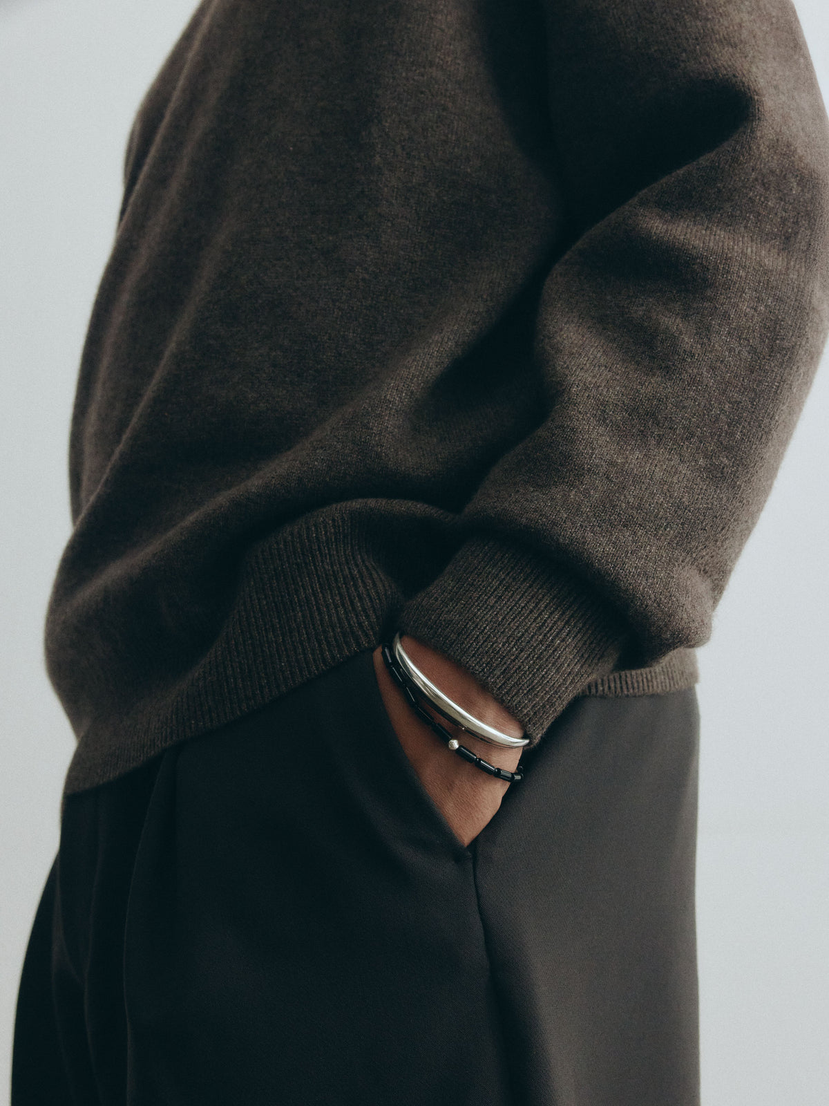 male model wearing .925 sterling silver AGMES cyril thin cuff bracelet with onyx vallen bracelet