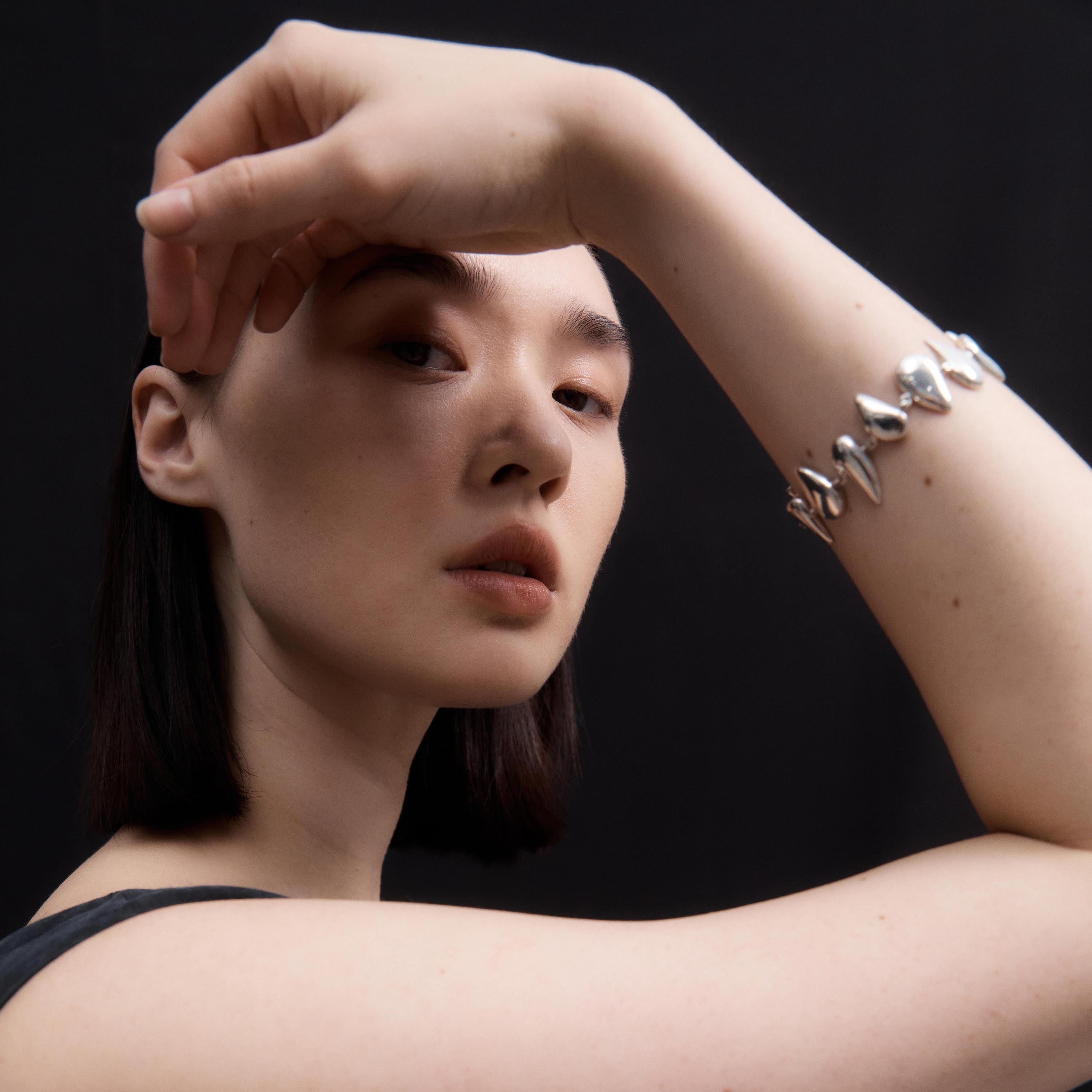 Woman wearing AGMES 0.925 sterling silver Flora Bracelet 
