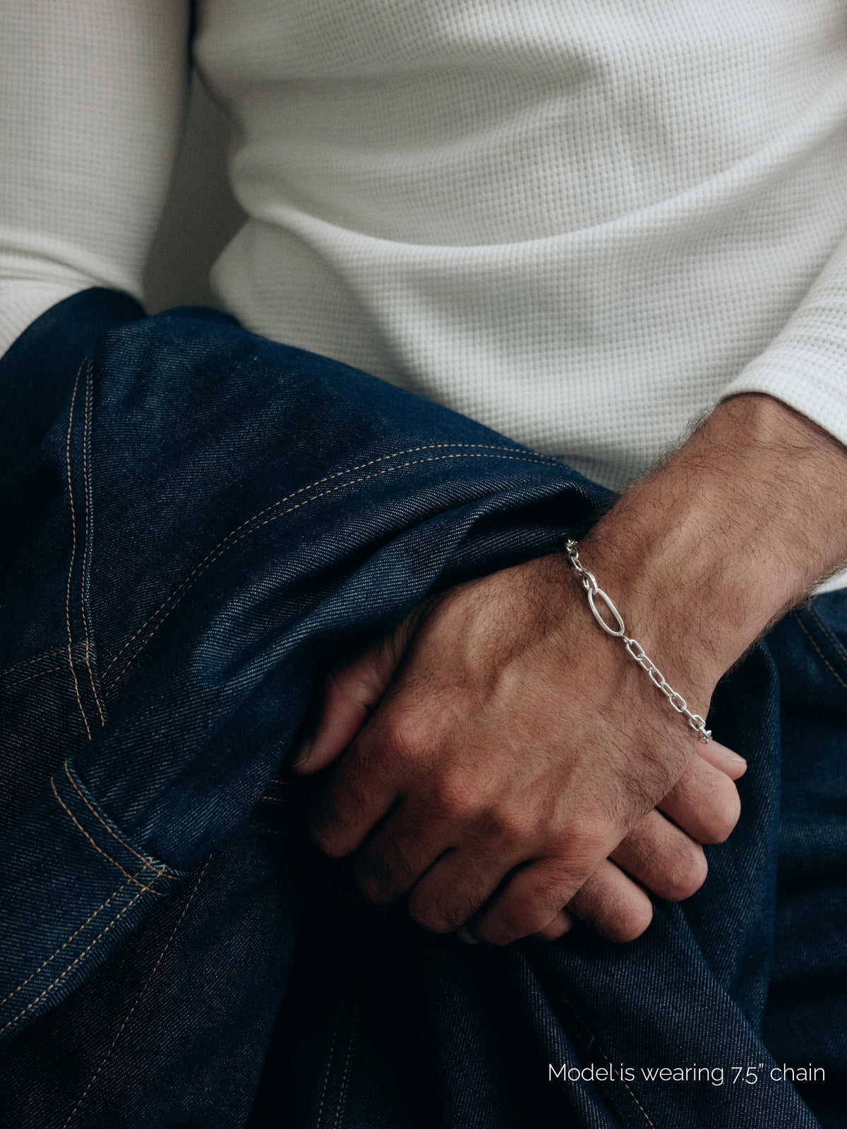 Model wearing AGMES .925 sterling silver 7.5 inch chain link Gabriel Chain Bracelet with denim jacket.