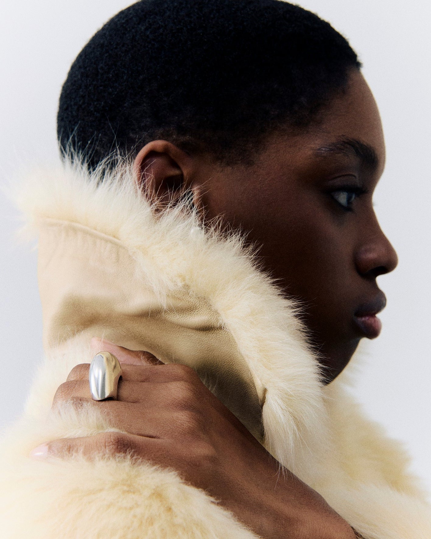Model wearing AGMES .925 sterling silver sculptural round wide Jouve Ring with fur coat.