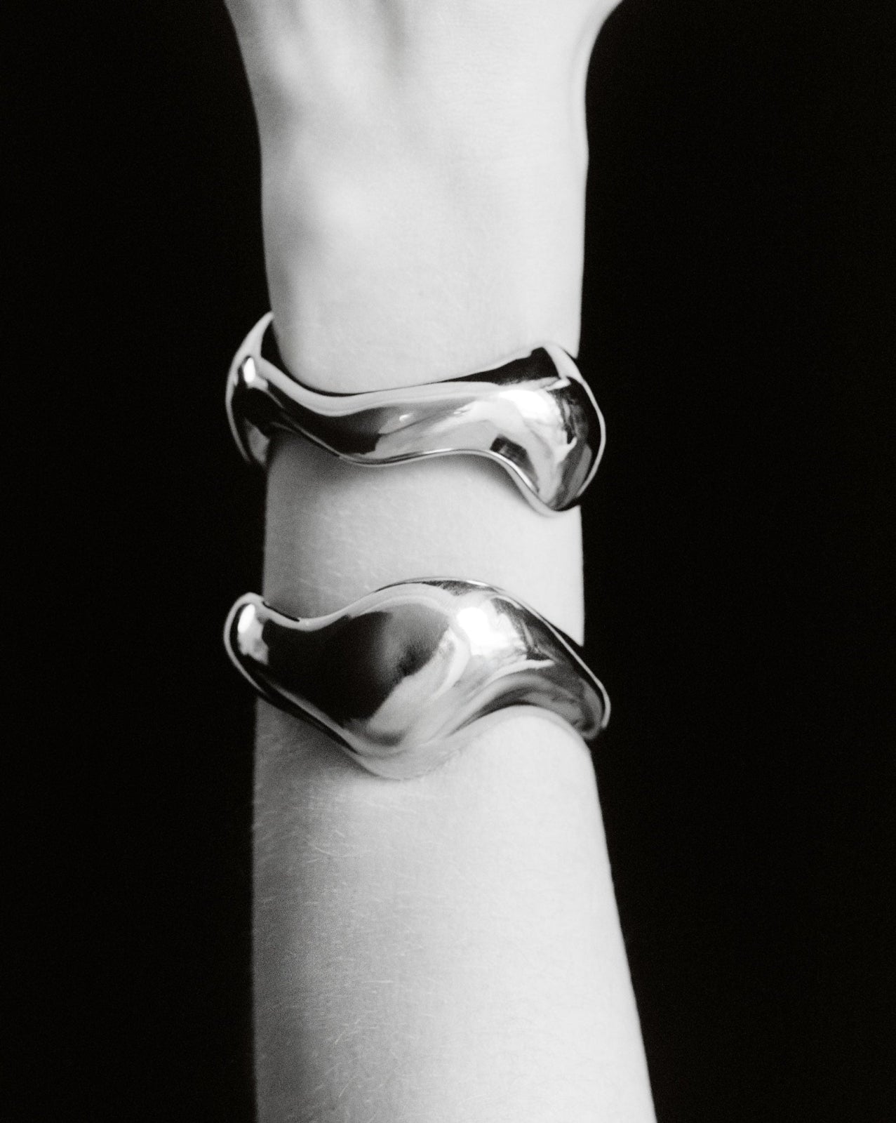 Person wearing AGMES 0.925 sterling silver sculpted abstract cuff set.