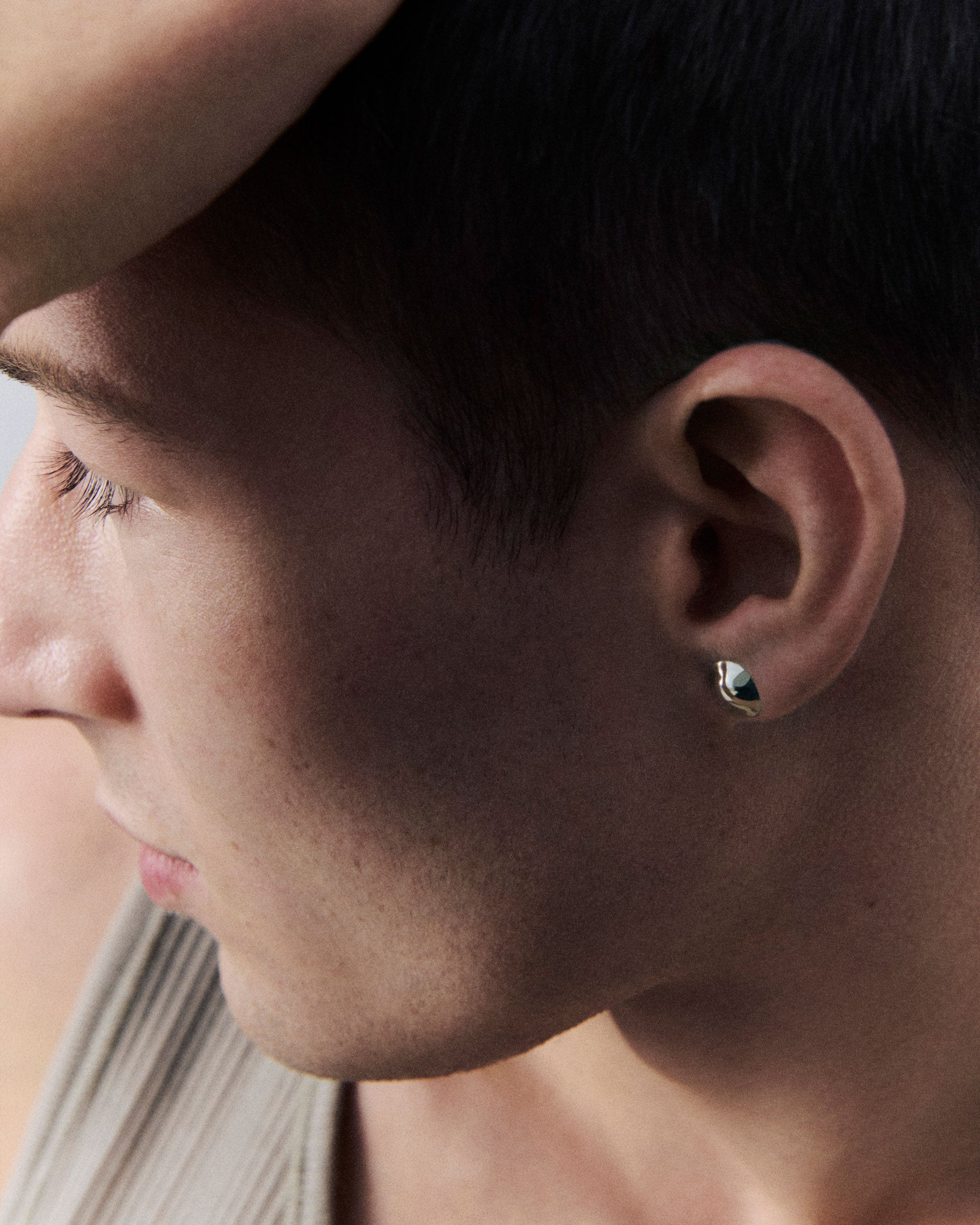 Man wearing AGMES .925 sterling silver Mini Cora Studs