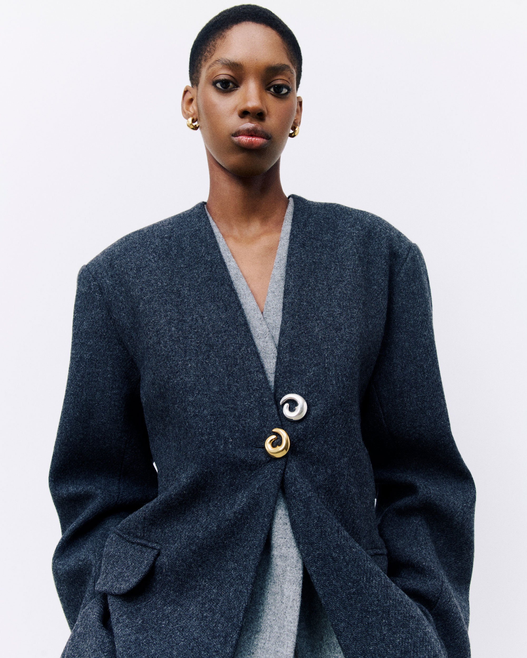 Model wearing AGMES Nadia Brooch in 18k Gold Vermeil and .925 Sterling Silver on cardigan