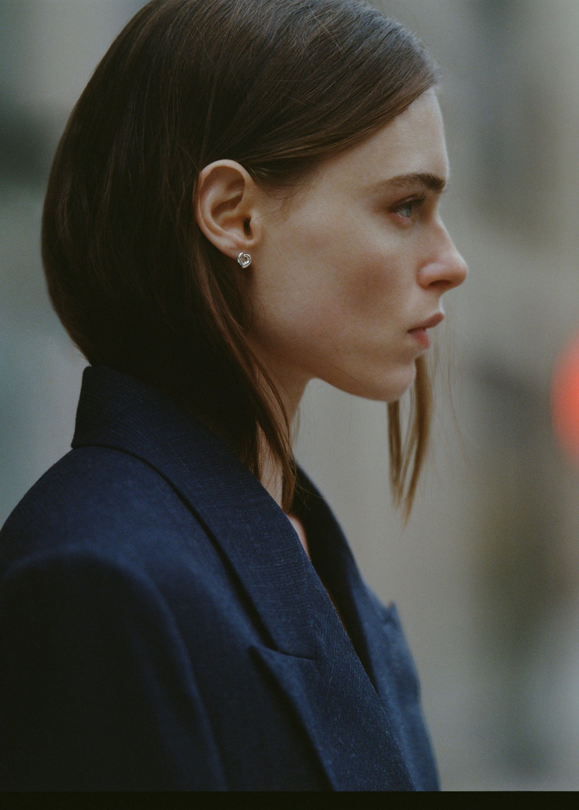 Model wearing AGMES .925 sterling silver sculptural heart spiral mini Nadia Stud earrings.