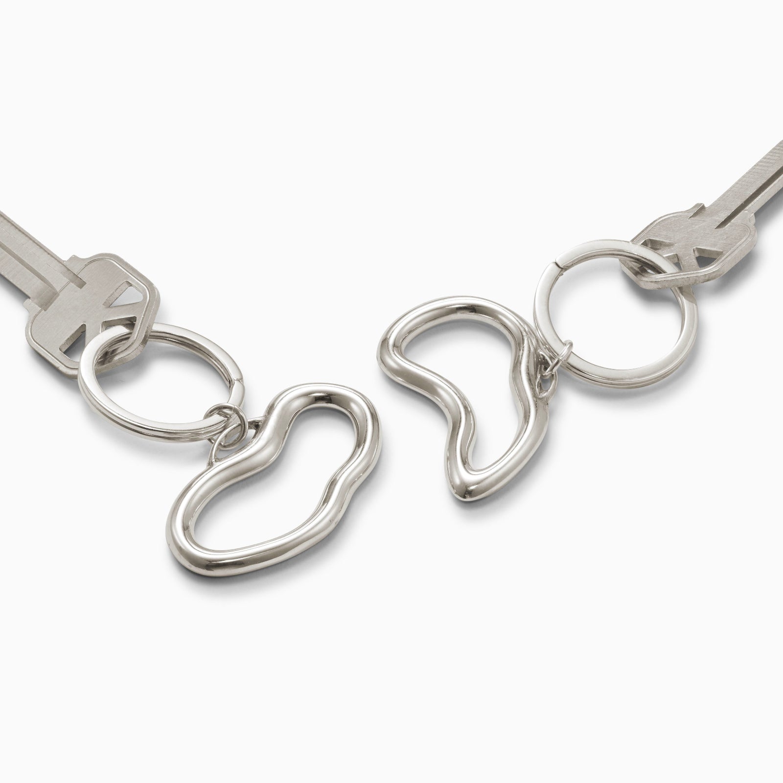 AGMES .925 sterling silver sculptural heart Sum of Parts Keychain set on white background.