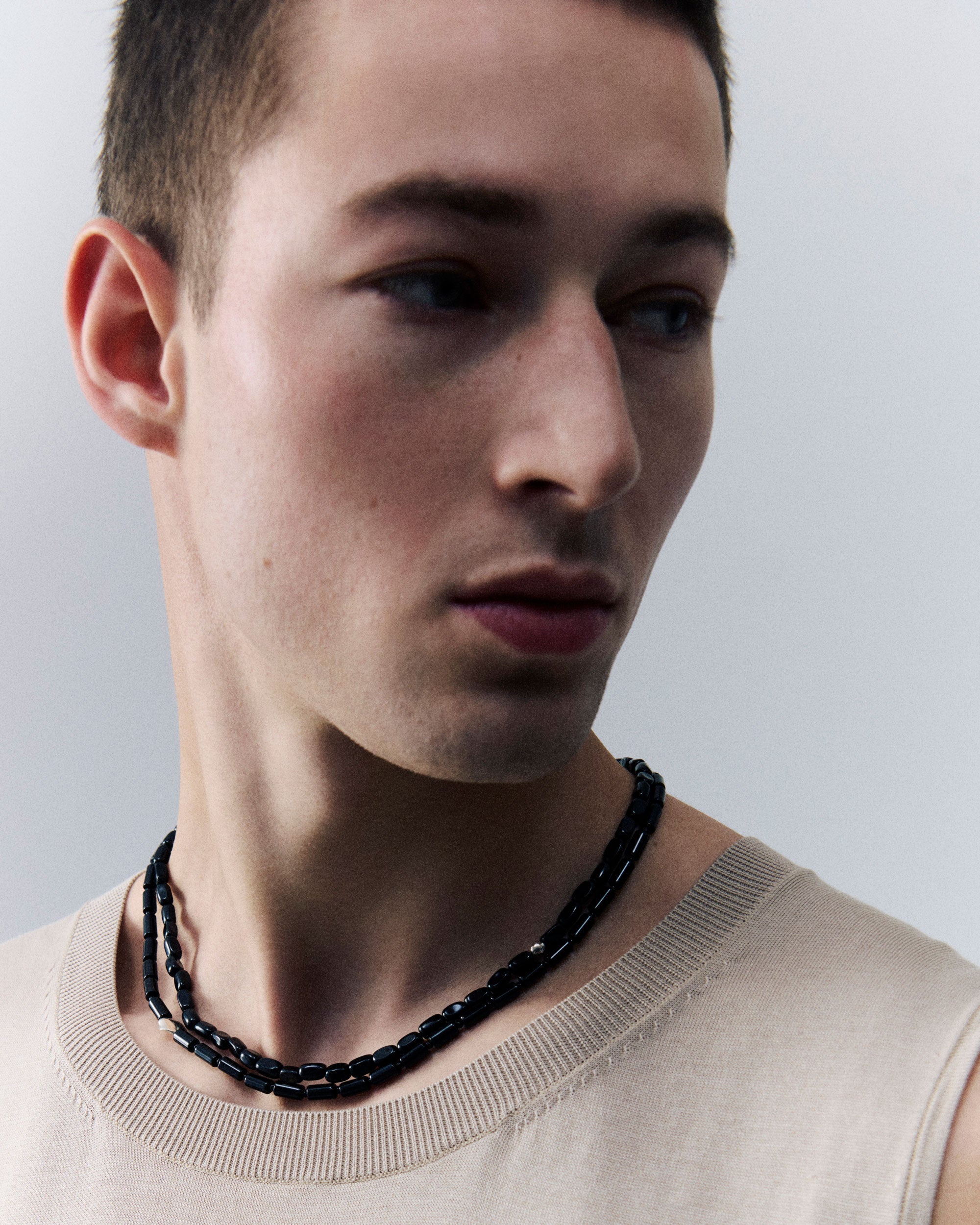 Man wearing onyx stone and .925 sterling silver AGMES Willa Necklace