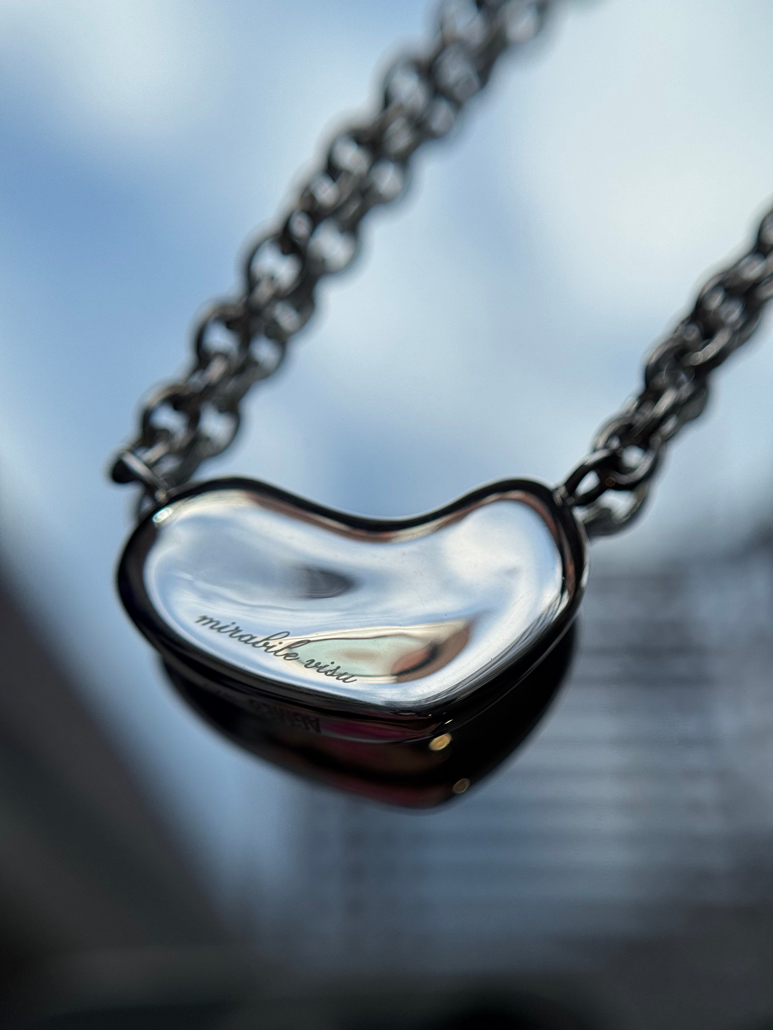AGMES .925 sterling silver Small Sculpted Heart Pendant II with engraving on reflective surface.