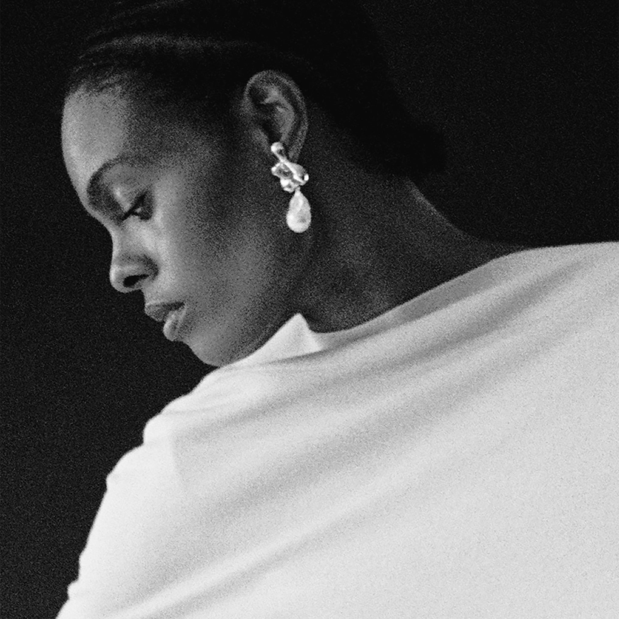 Woman wearing AGMES 0.925 sterling silver sculpted earrings with freshwater pearl drop. Simone Bodmer-Turner.