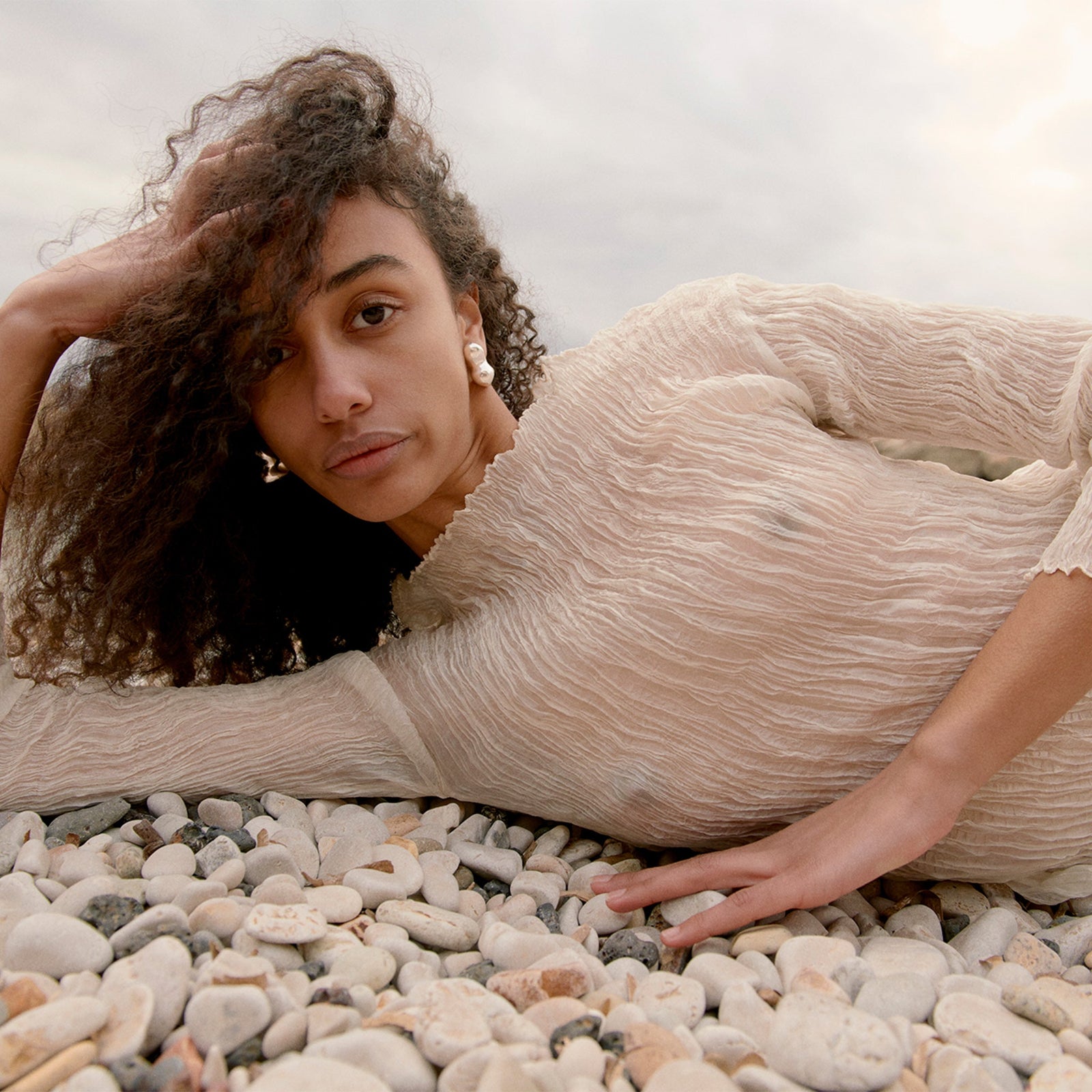 Woman wearing AGMES 0.925 sterling silver sculpted bubble hoop earrings. Simone Bodmer-Turner.