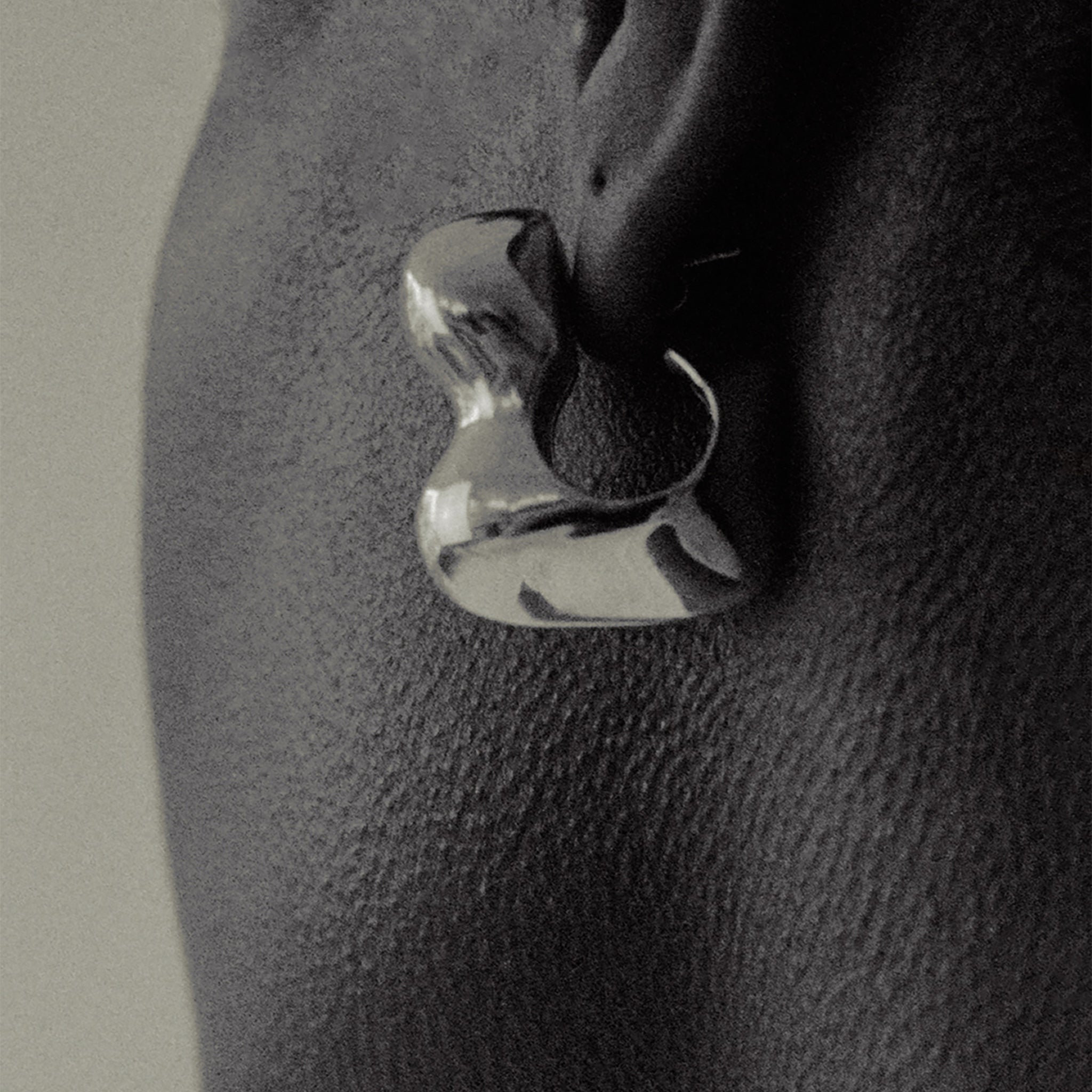 Person wearing AGMES 0.925 sterling silver sculpted bubble hoop earrings. Simone Bodmer-Turner.