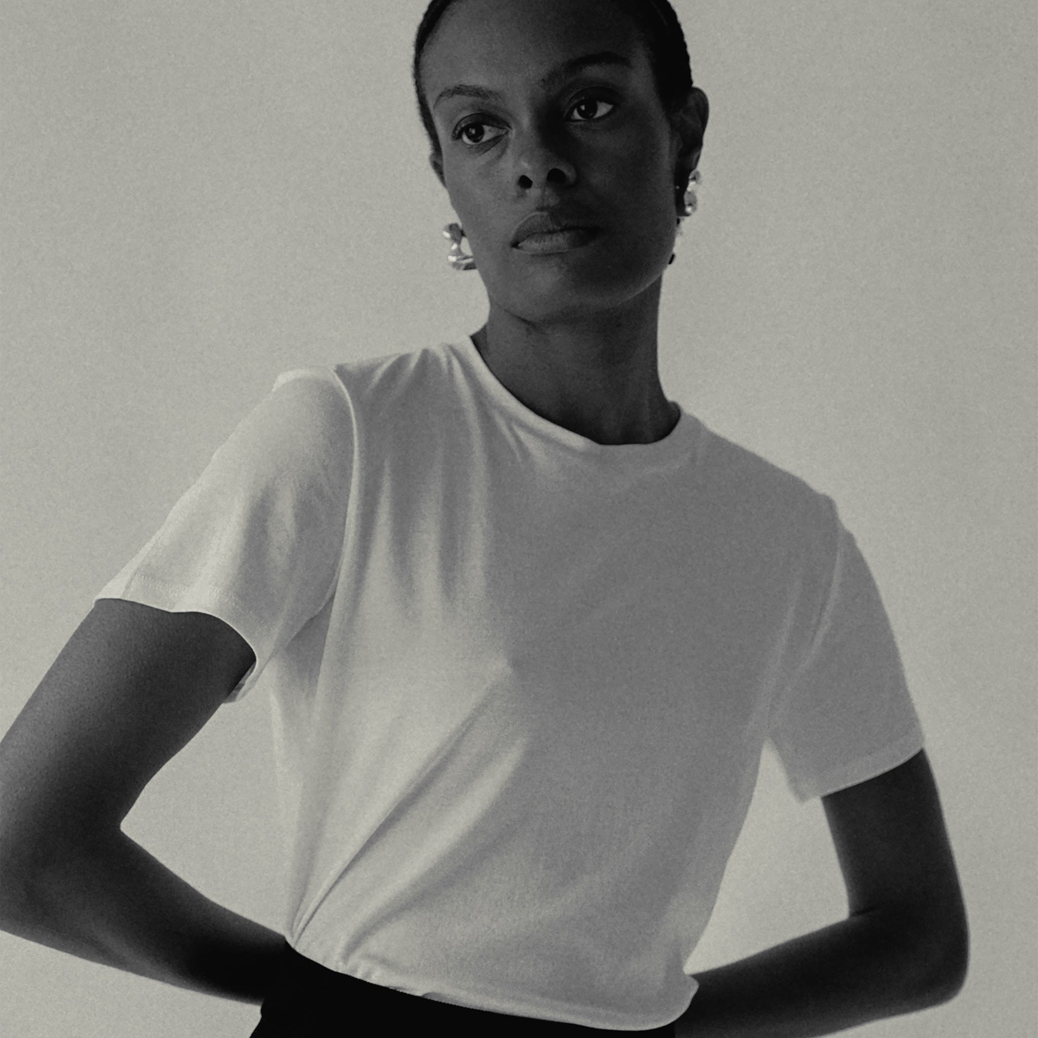 Woman wearing AGMES 0.925 sterling silver sculpted bubble hoop earrings. Simone Bodmer-Turner.