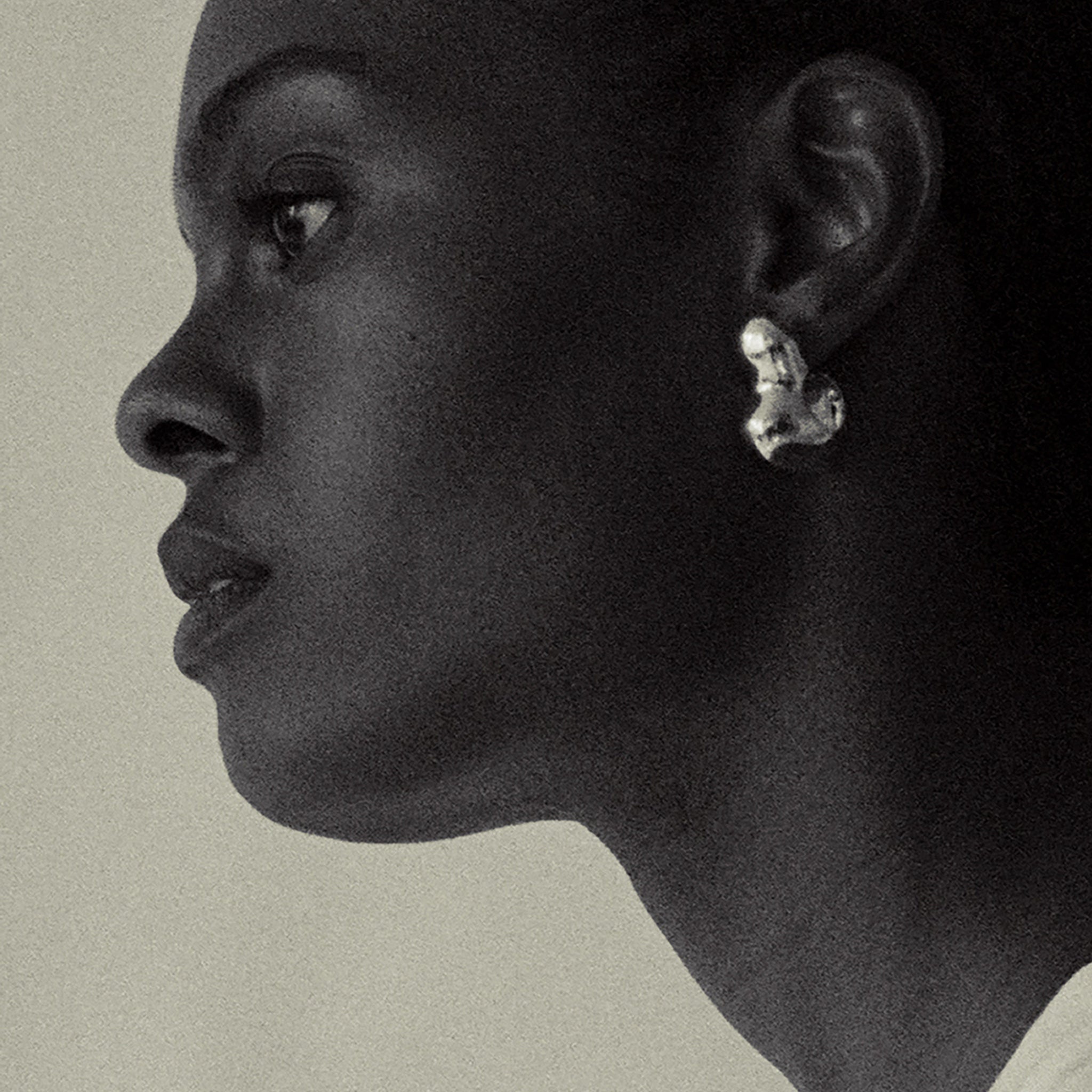 Woman wearing AGMES 0.925 sterling silver sculpted bubble hoop earrings. Simone Bodmer-Turner.