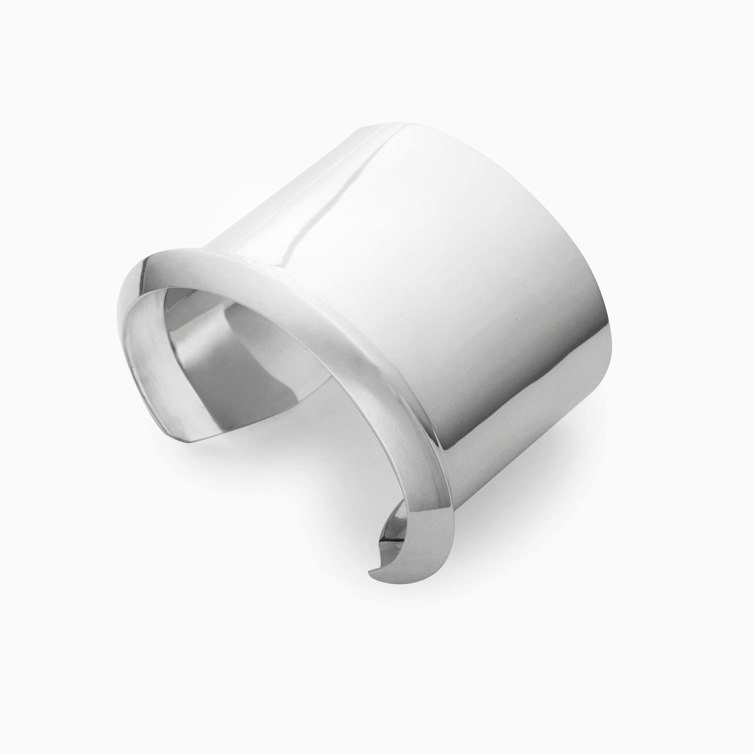 AGMES Cliff_Cuff Simple and modern cuff with a geometric scallop detail on one edge. Measures 1-7/8" wide, sterling silver.