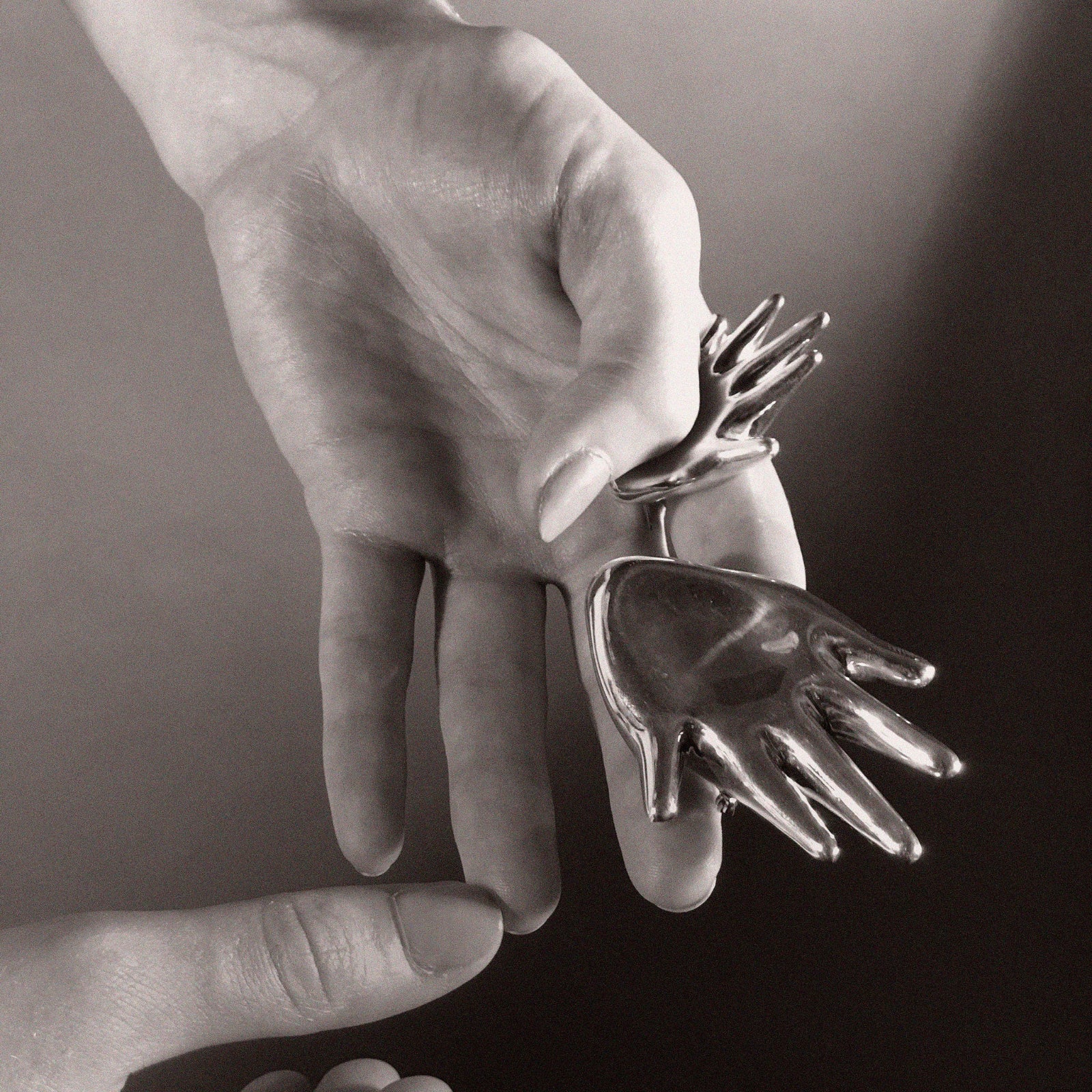 Person holding AGMES .925 Sterling Silver Dali Brooch and Large Dali Brooch. Hand shaped Brooch. 
