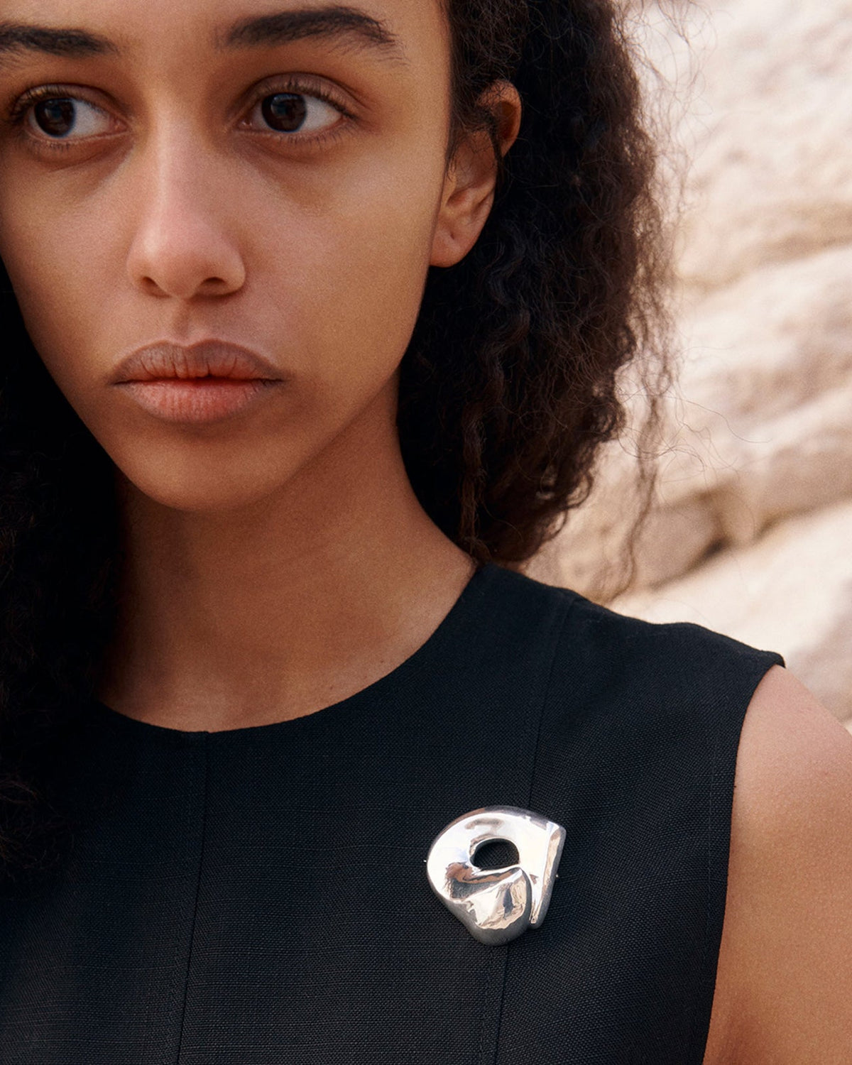 Woman wearing AGMES .925 Sterling Silver Gertrude Brooch on black dress. Simone Bodmer-Turner.