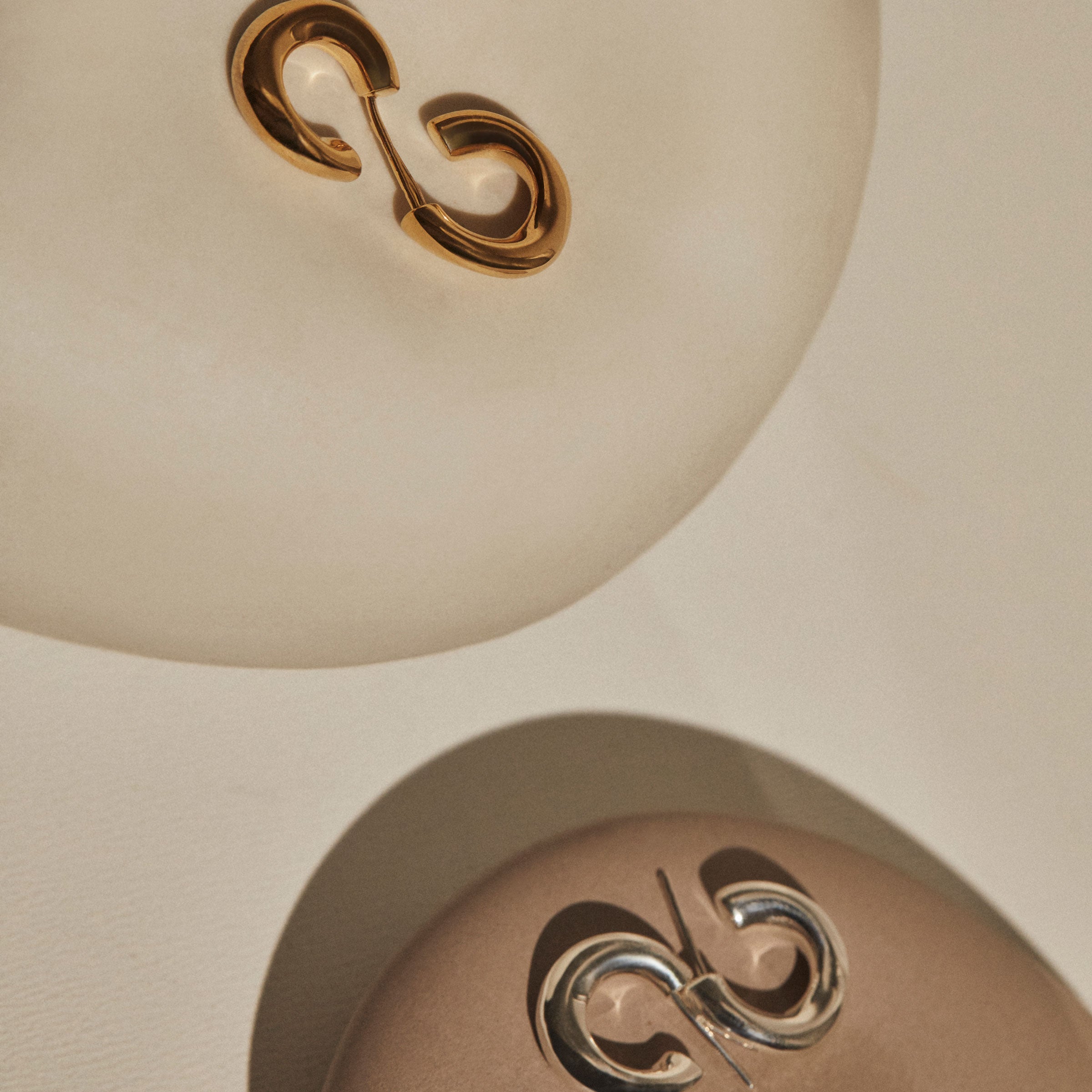 AGMES 0.925 sterling silver and 18k gold vermeil mini hoop earrings.