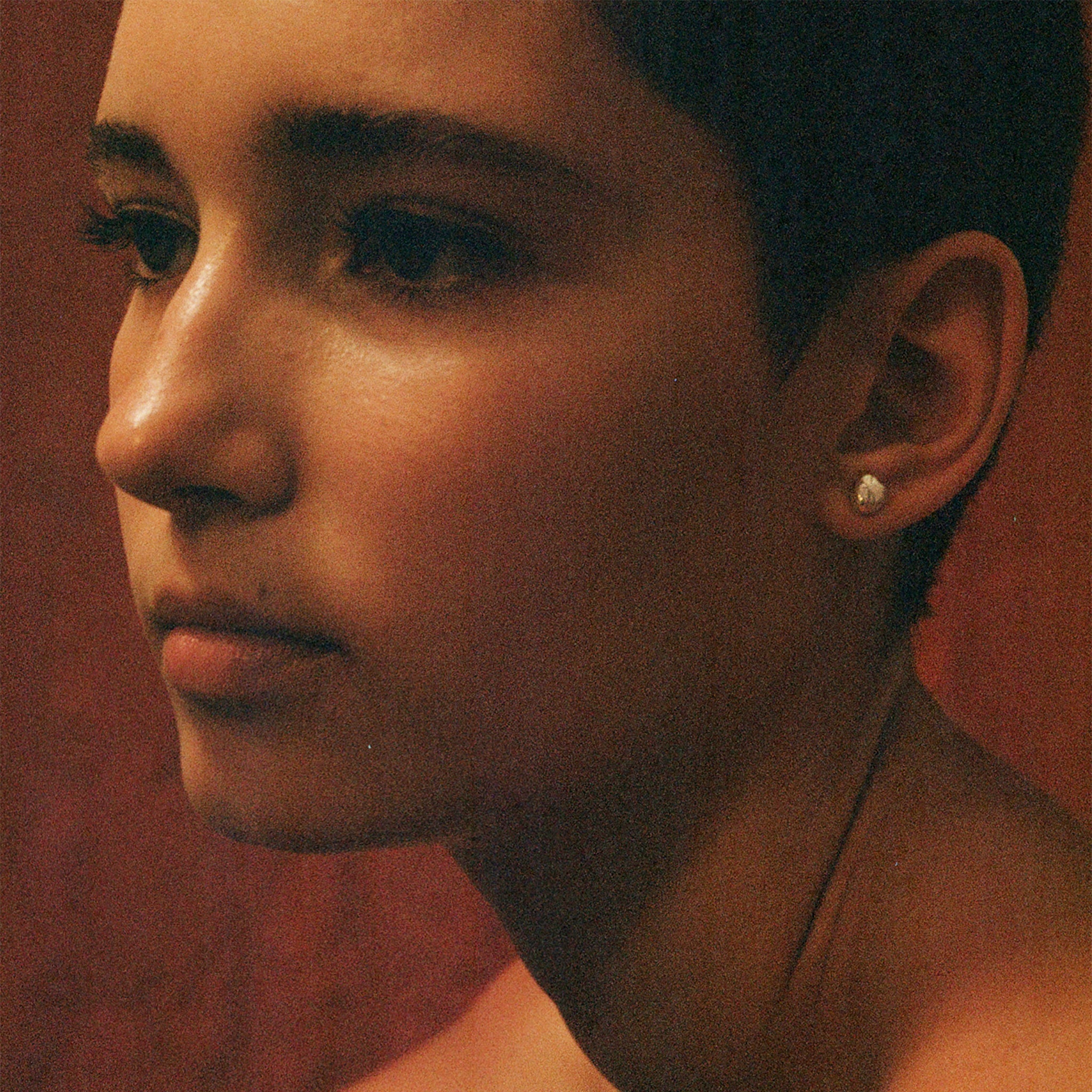 person wearing AGMES pearl stud earrings.