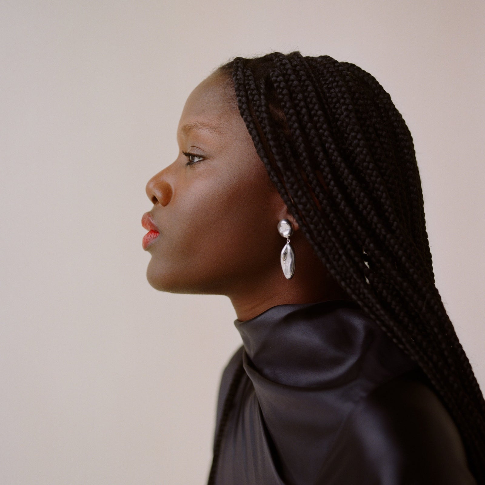 Woman wearing AGMES 0.925 sterling silver sculpted drop earrings.