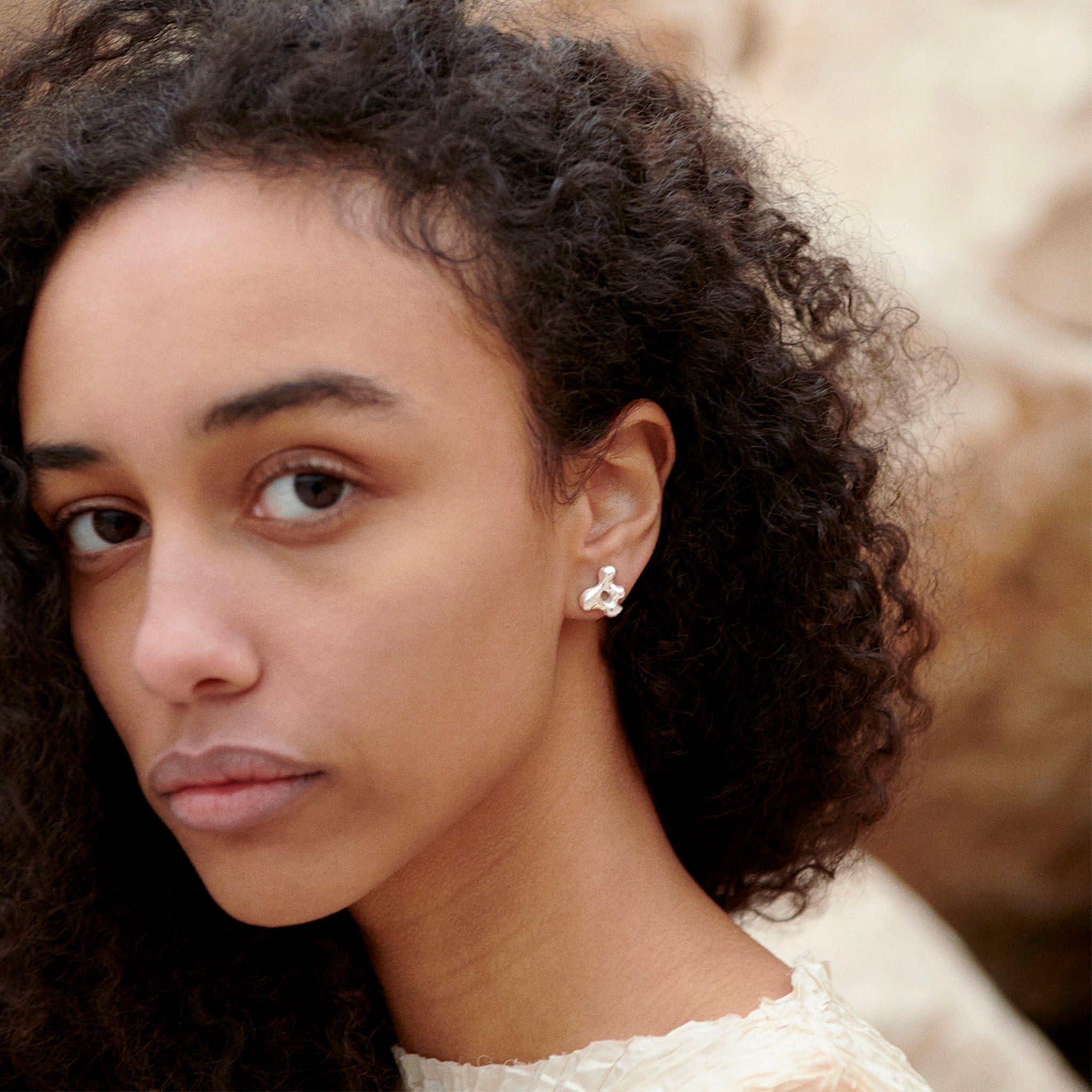 Woman wearing AGMES 0.925 sterling silver sculpted stud earrings. Simone Bodmer-Turner.