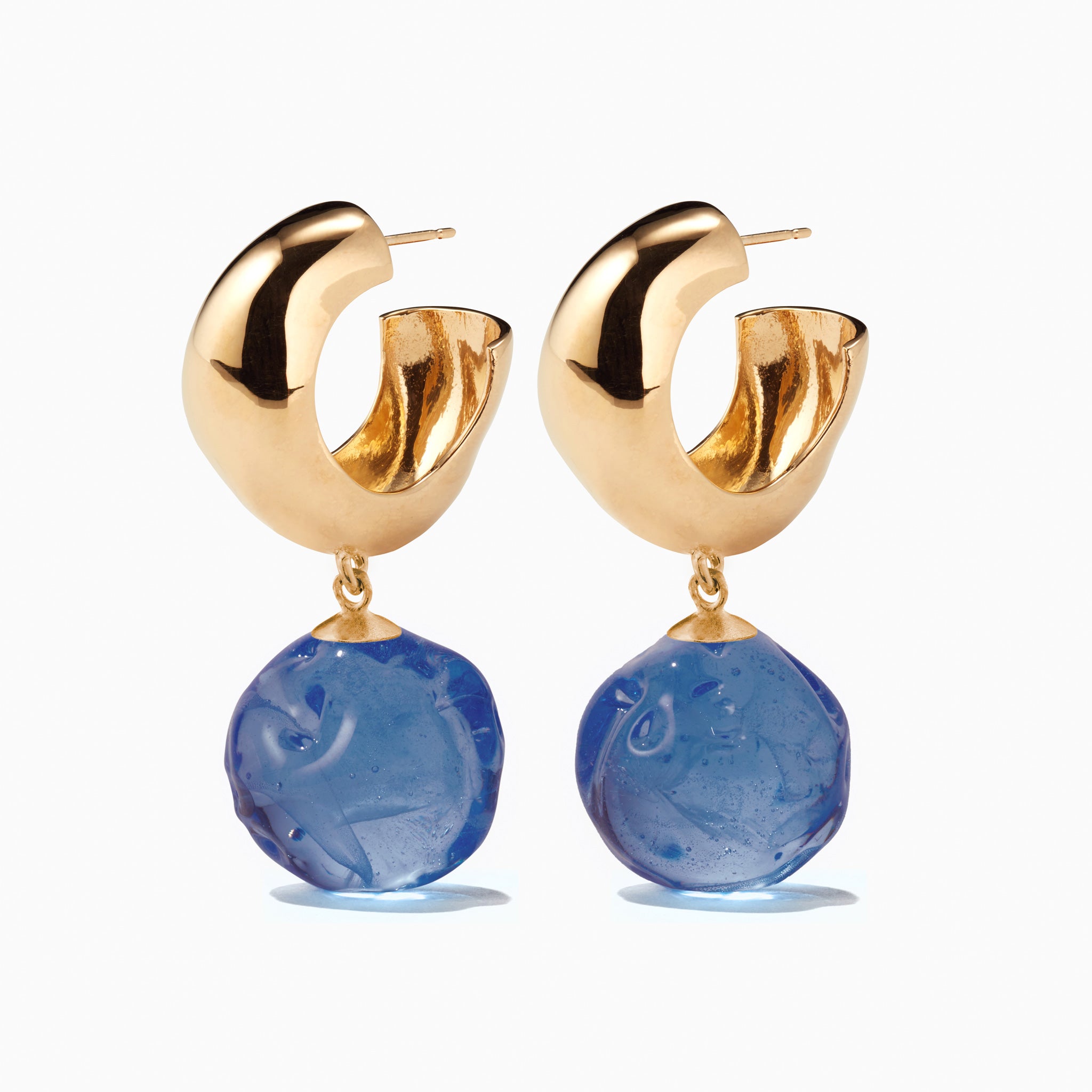 AGMES yellow gold vermeil small Cleo hoop earrings with blue glass bead drop on white background.