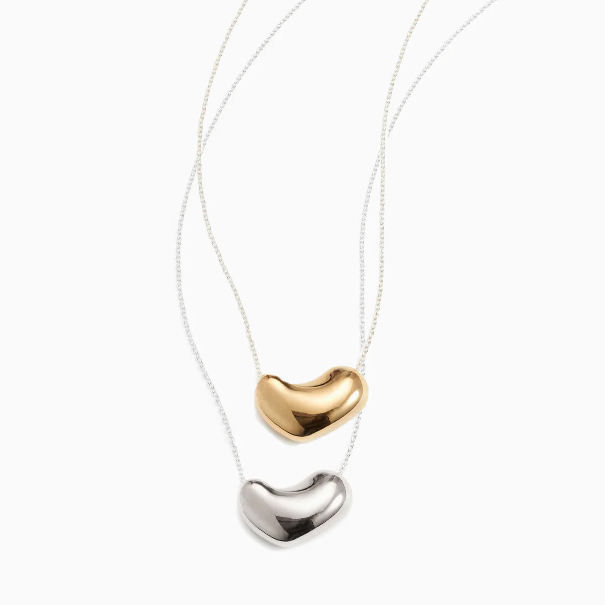 AGMES 925 sterling silver and 14k gold vermeil Small Sculpted Heart Pendant set on white background.