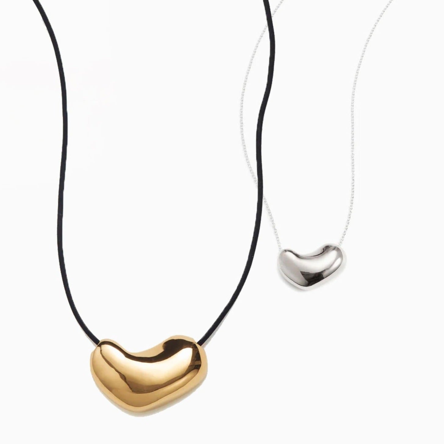 AGMES .925 Sterling Silver Small Sculpted Heart Pendant on chain necklace paired with the 18K Gold Vermeil Sculpted Heart Pendant on a Black Suede Cord. 