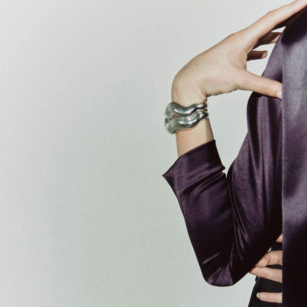 Person wearing AGMES 0.925 sterling silver large Astrid sculpted cuff bracelet.