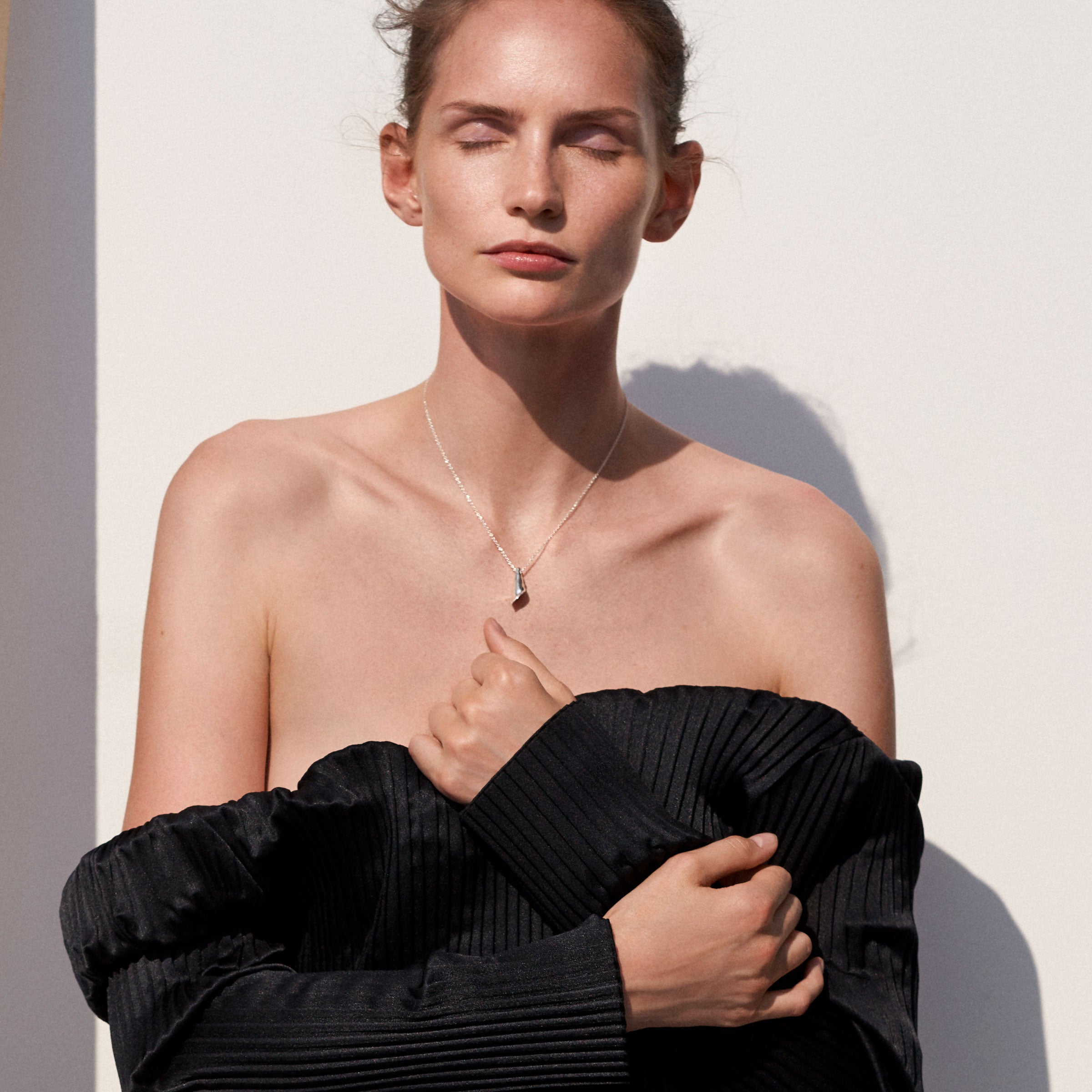 Woman wearing AGMES .925 Sterling Silver Mini Calla Pendant paired with Sterling Silver Chain necklace. 