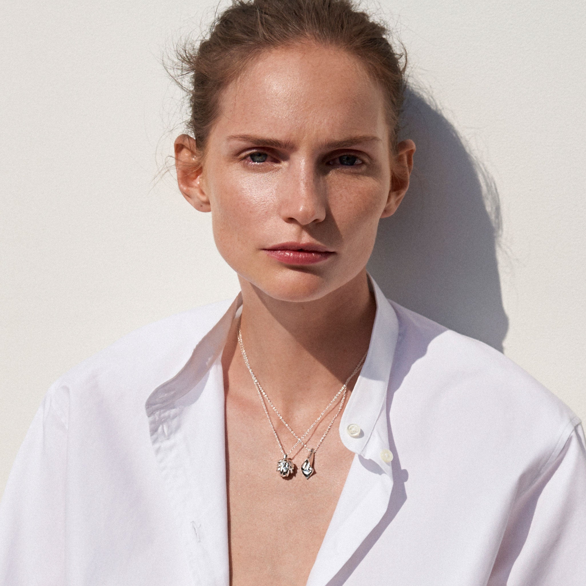 Woman wearing AGMES .925 Sterling Silver Mini Calla Pendant paired with Sterling Silver Chain necklace. Artichoke Pendant Necklace. 