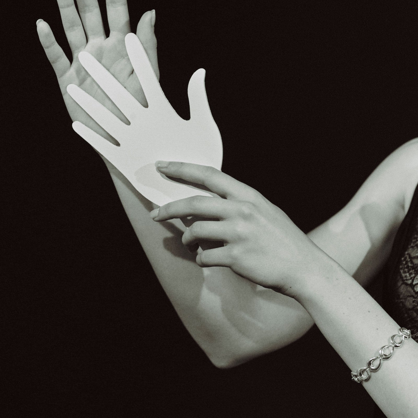 Model wearing AGMES .925 sterling silver sculptural link Thin Tilda bracelet. Black and white image.