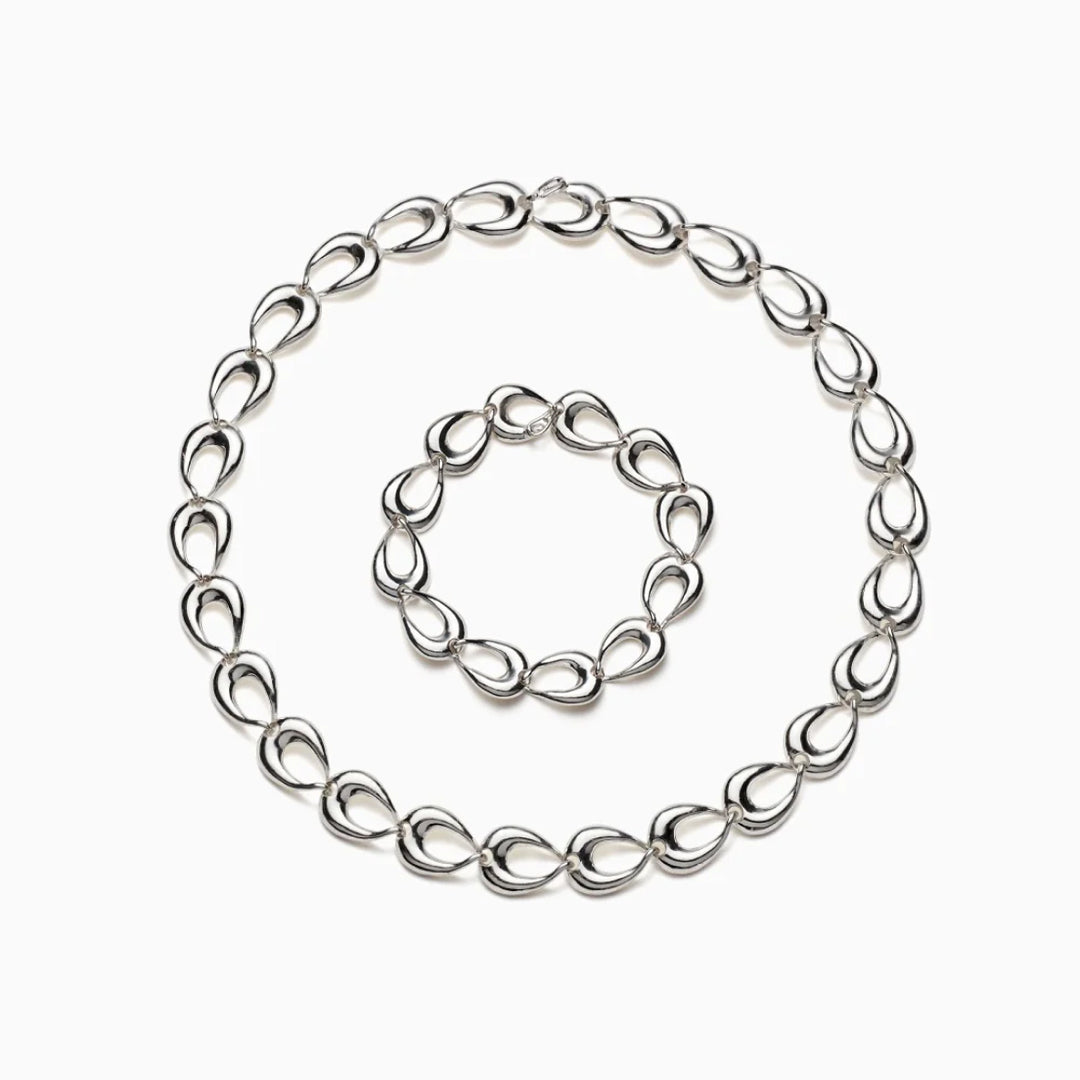 AGMES .925 sterling silver sculptural link Tilda Necklace and Tilda Bracelet on white background.