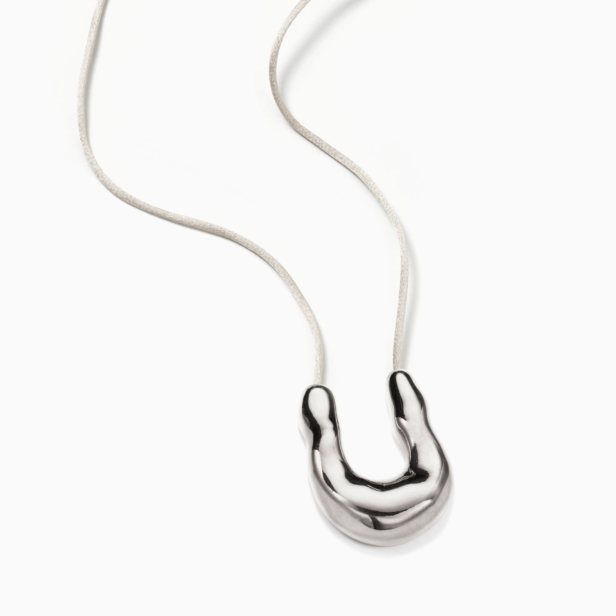 AGMES 0.925 Sterling Silver Wishbone Pendant on Ivory Satin Cord on white background.