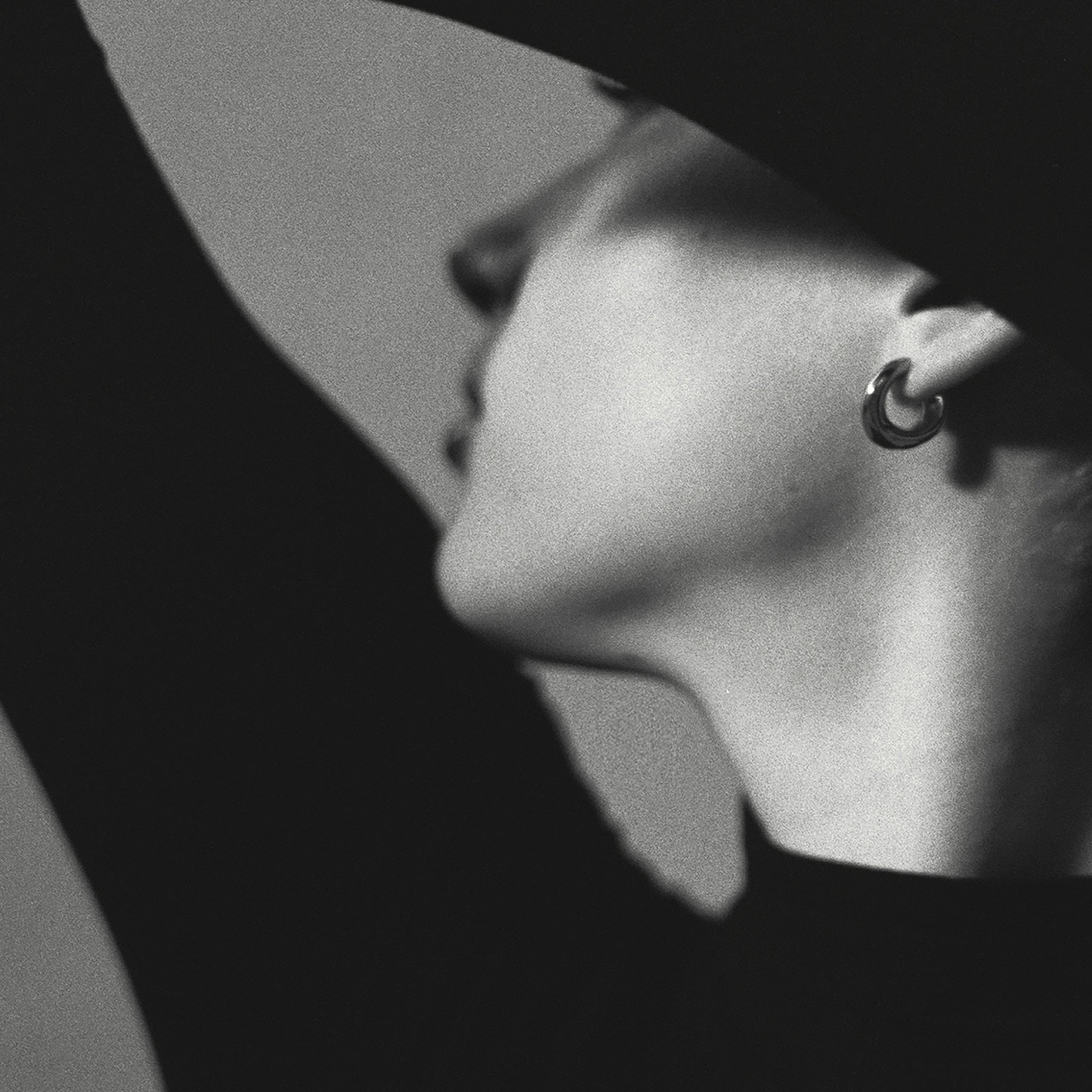 Person wearing AGMES 0.925 sterling silver mini hoop earrings.