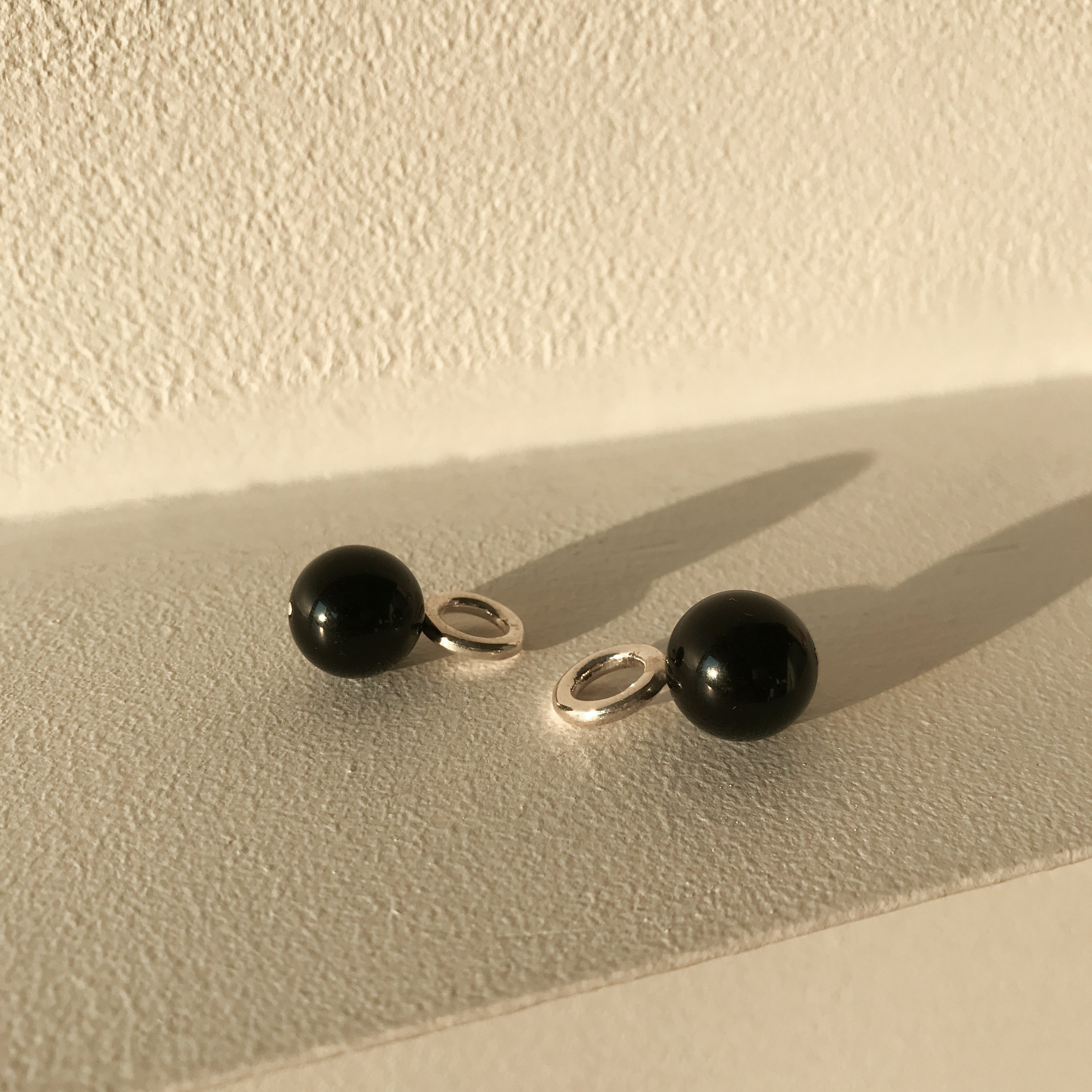AGMES 0.925 sterling silver and onyx earring embellishment.